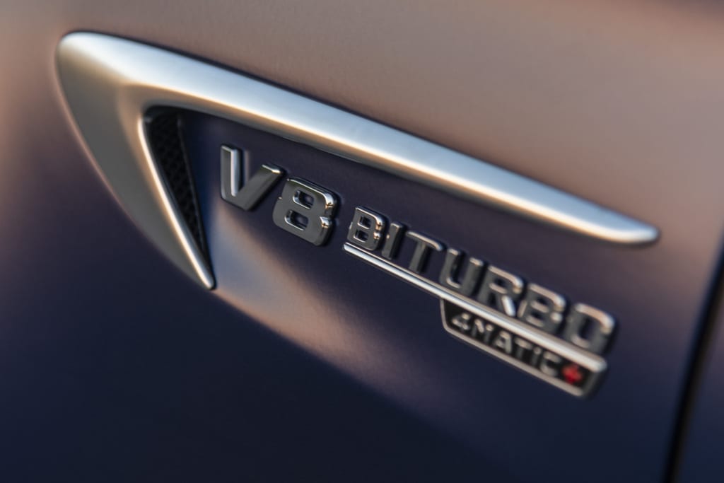 A close-up of the V8 Biturbo badge on a Mercedes AMG