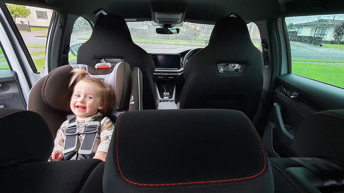 Smiling toddler in a SKODA Octavia RS wagon