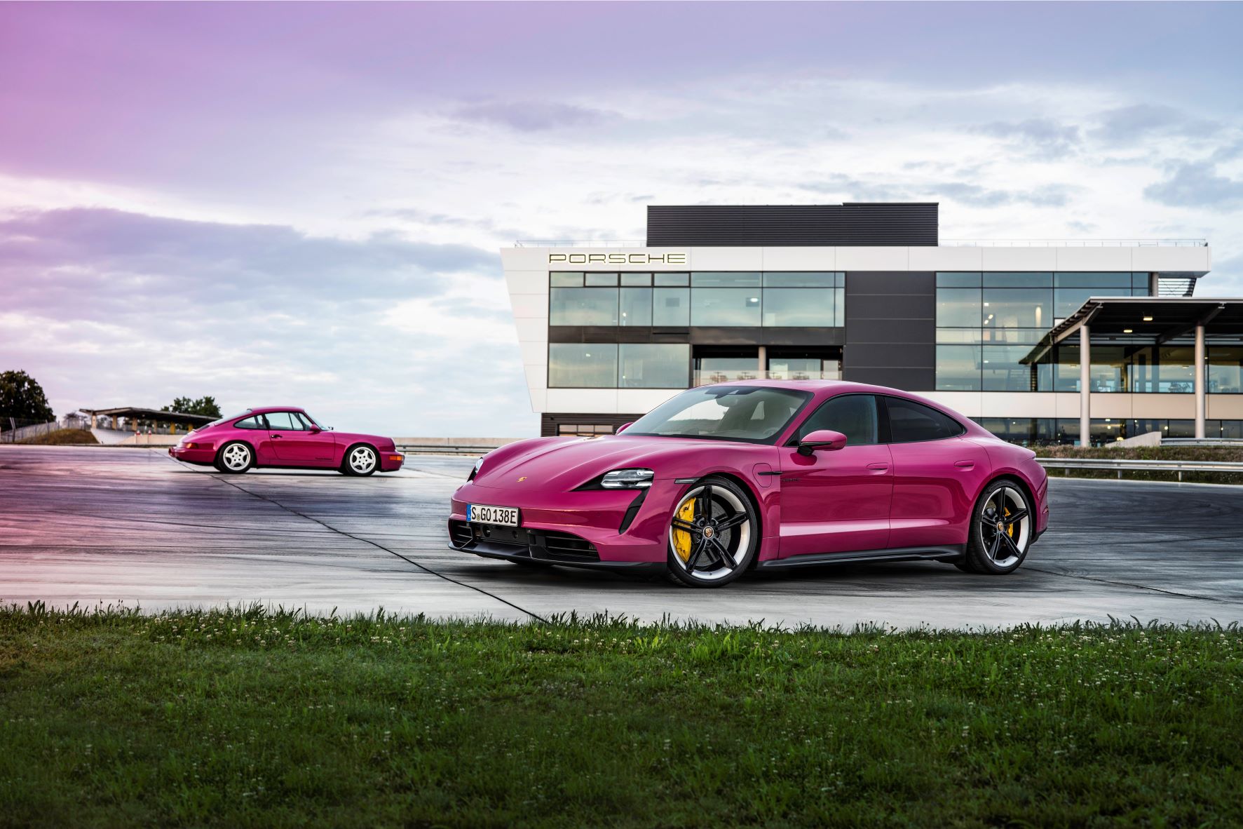 Porsche Taycan and 964 911 in Rubystone Red