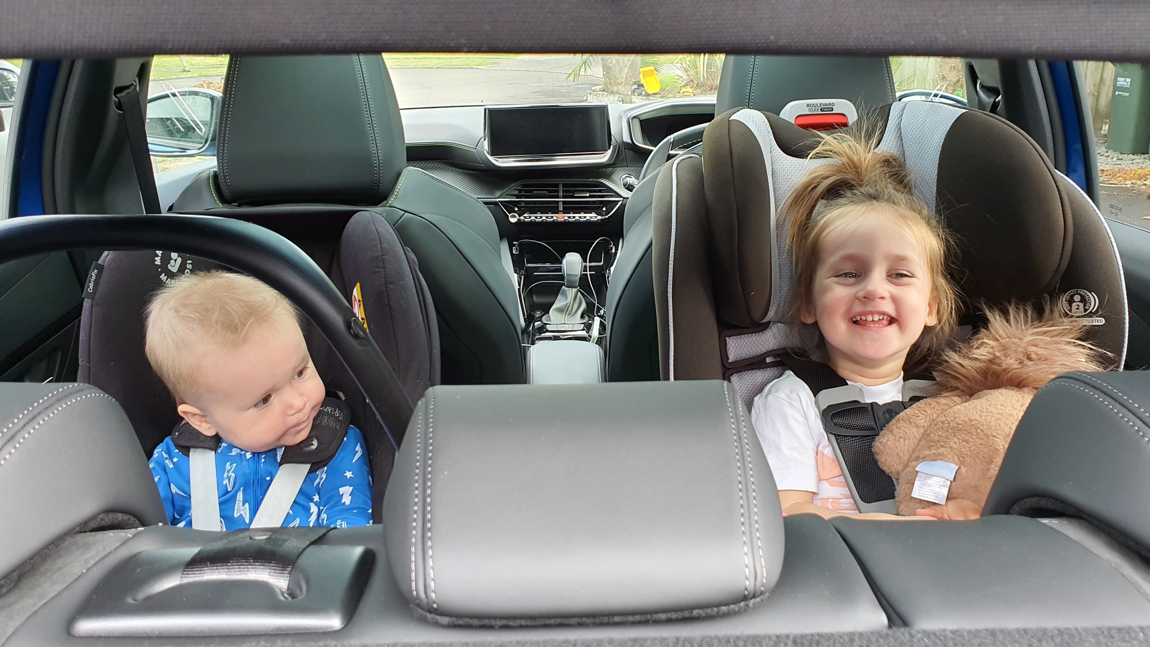 2 children in the back seat of a 2022 Peugeot 208 GT.