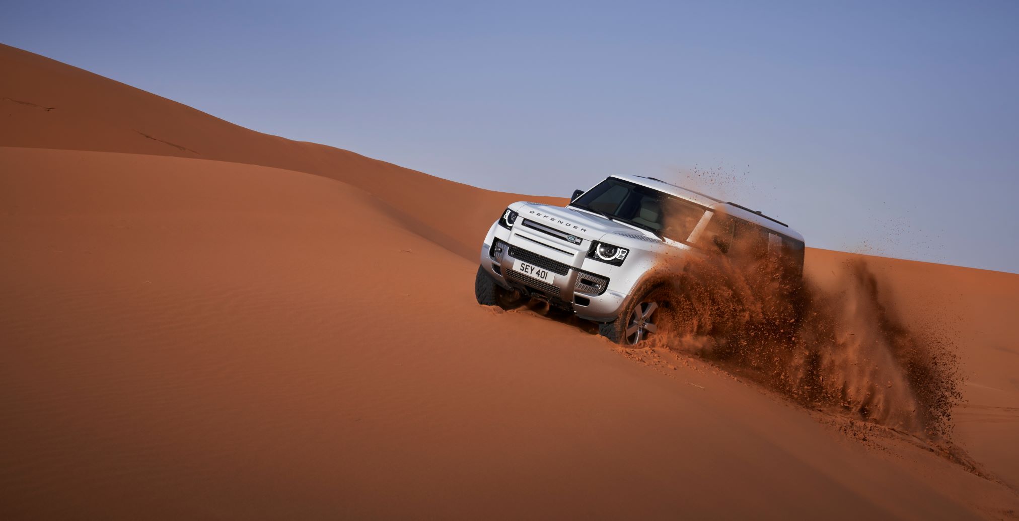 New Land Rover Defender 130 off-roading in a desert