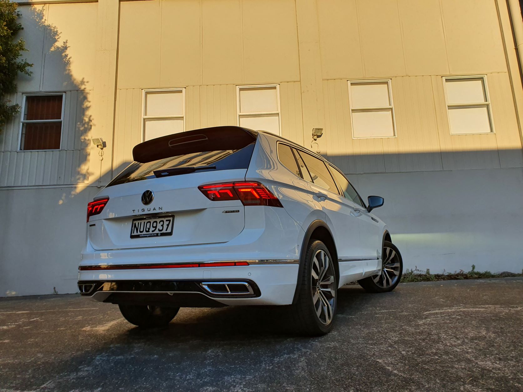 Rear three quarters view of the Volkswagen Tiguan Allspace R-Line at sunrise