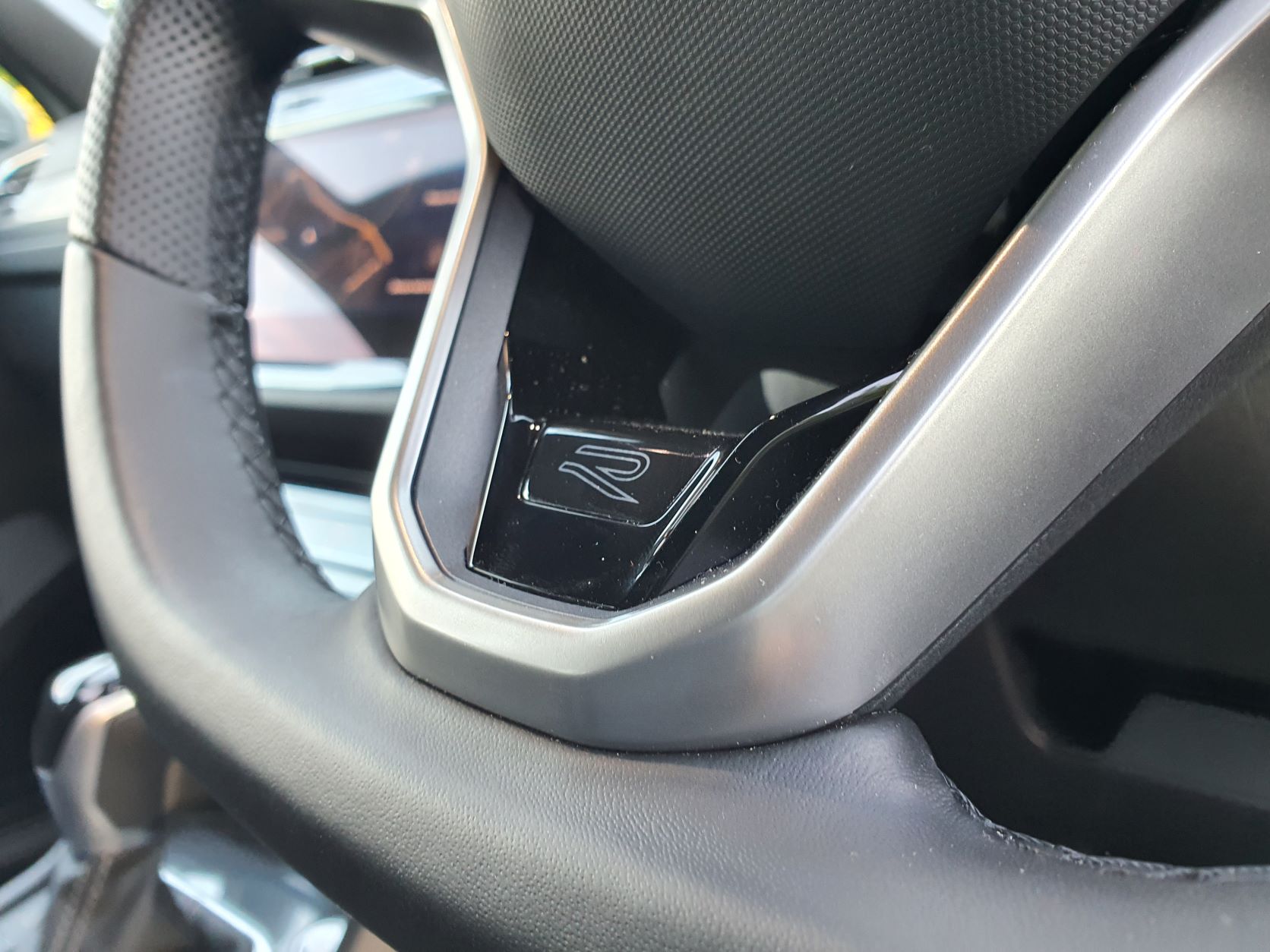 Volkswagen R brand badging on the steering wheel of the 2022 Volkswagen Tiguan Allspace R-Line