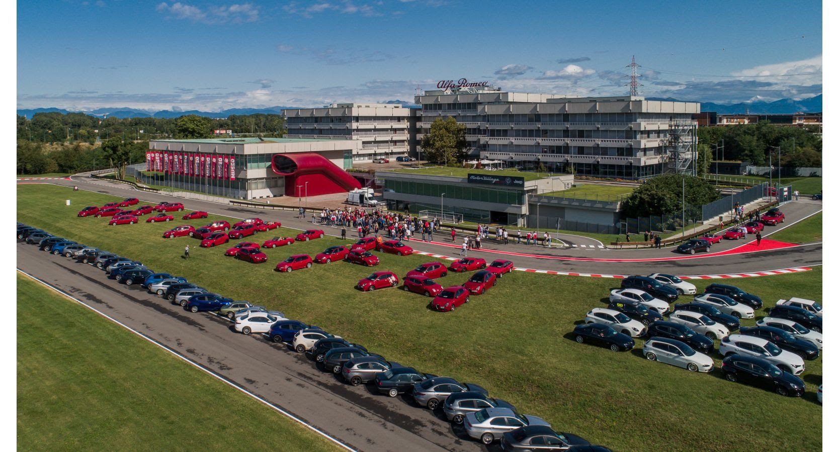 Alfa Romeo enthusiasts display their cars outside the Alfa Romeo museum in Arese