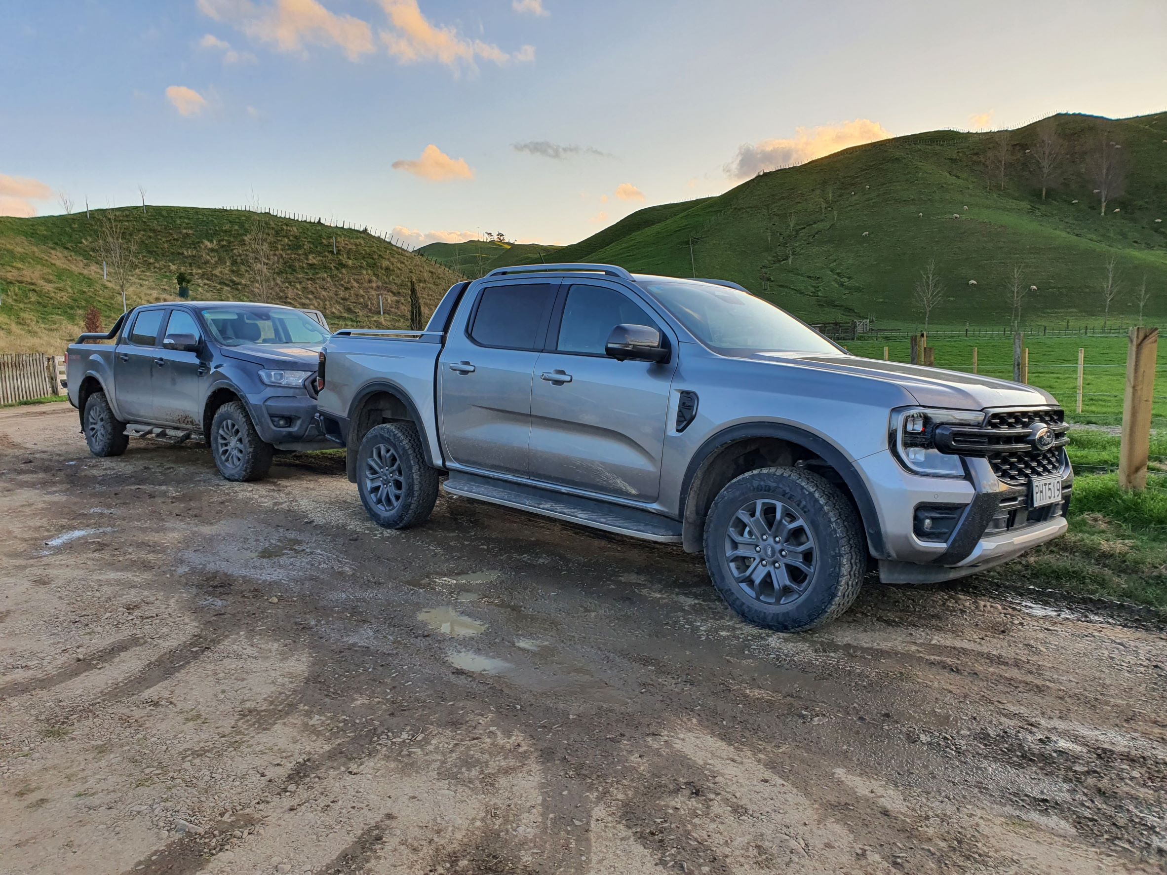 A new Ford Ranger Wiltrak in silver parked in front of an old Ford Ranger FX4 in grey