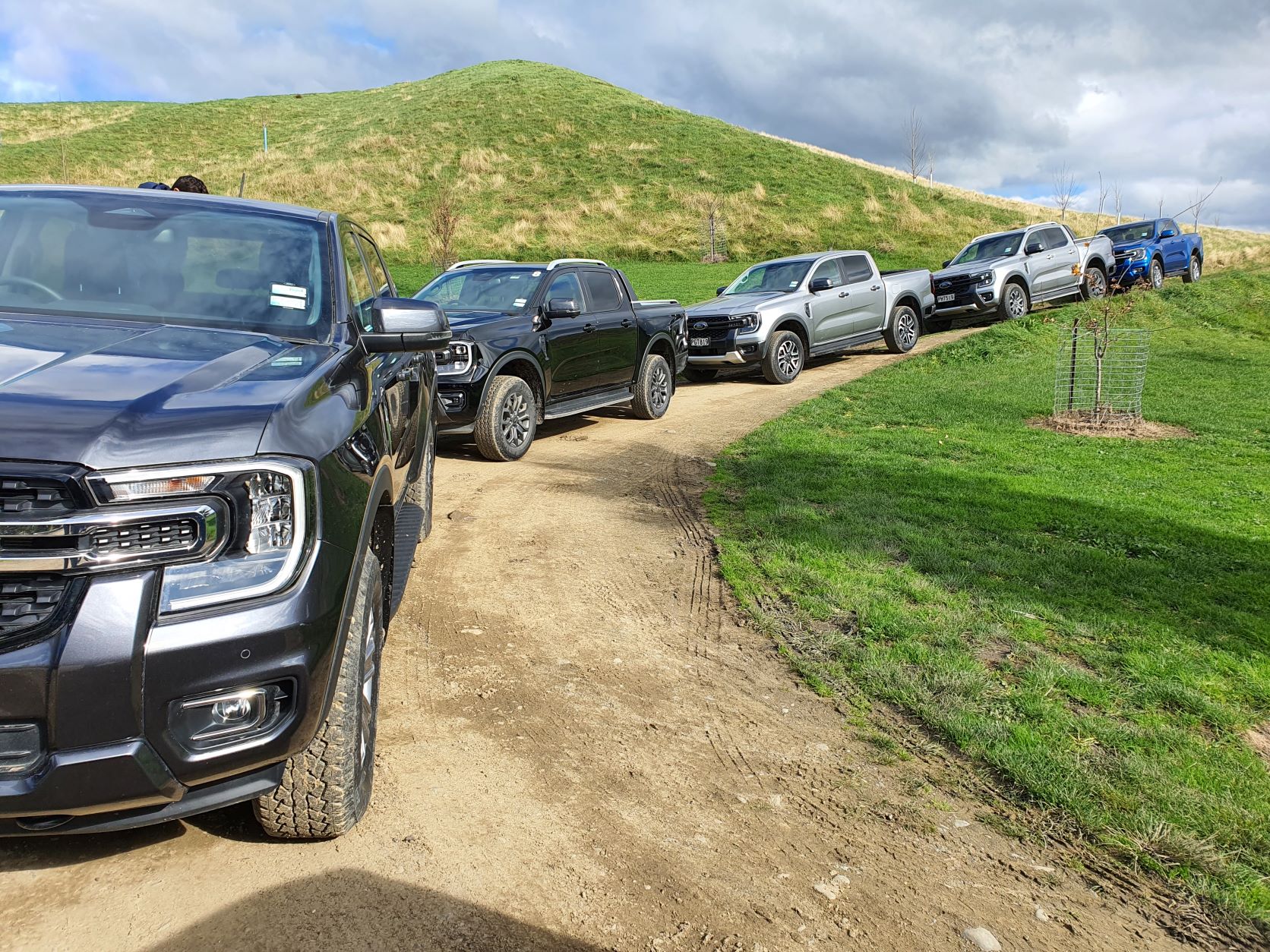 A line of 2022 Ford Ranger models including Wiltrak, Bi-Turbo and painted in grey, black, silver and blue.