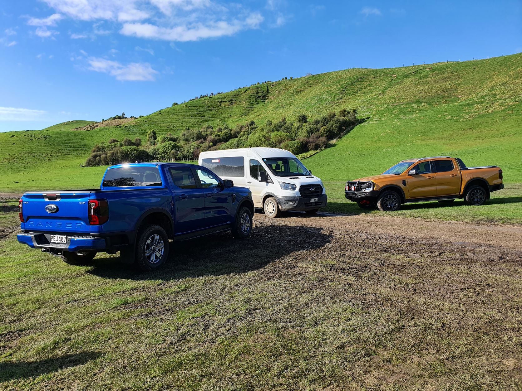 Two new Ford Rangers, a blue XLT Bi-Turbo and a gold Wildtrak flanking a white Transit van that brought us to the venue.