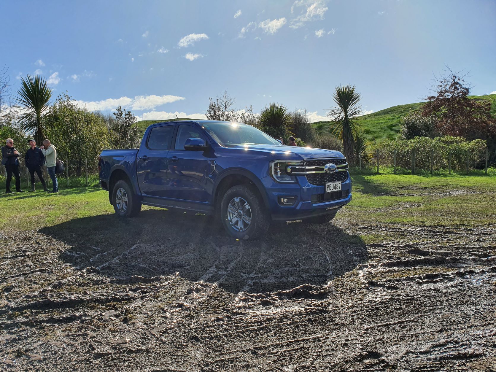A 2022 Blue Ford Ranger XLT BiTurbo in a muddy field