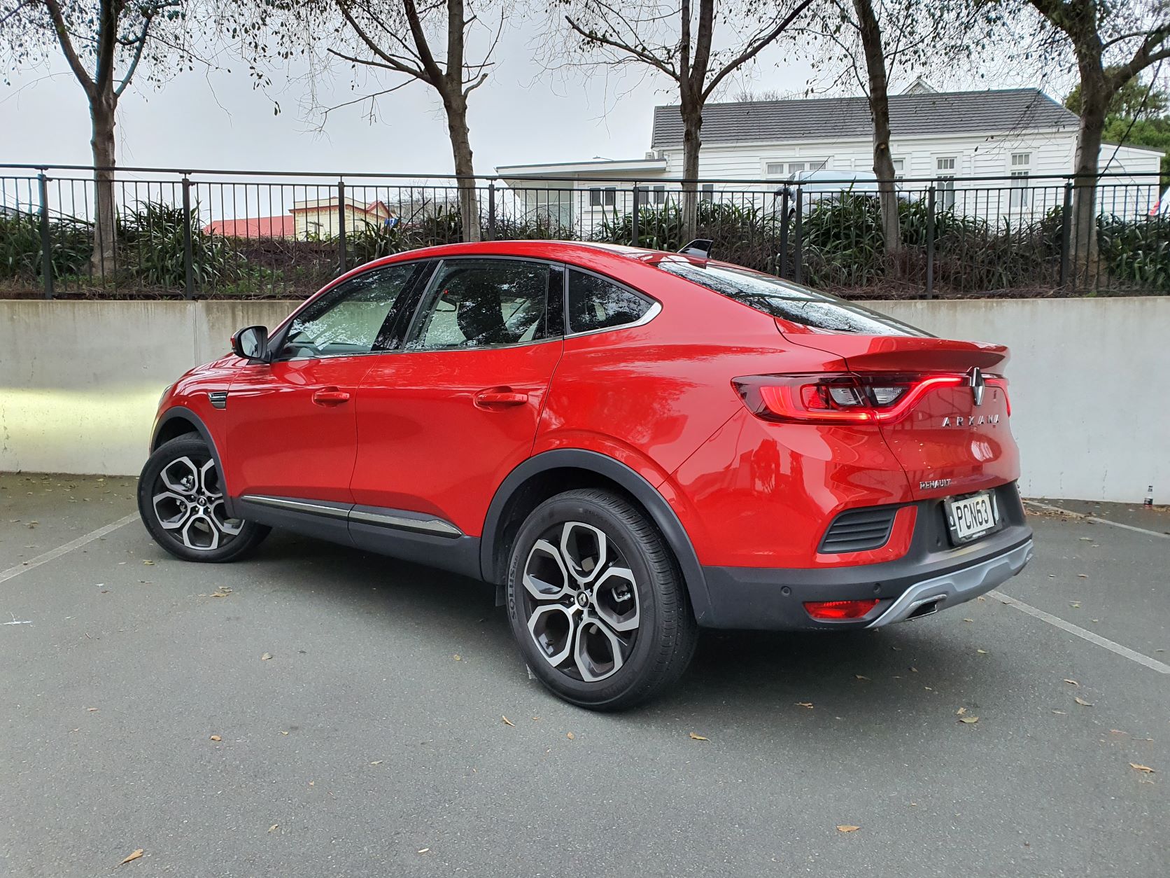 Rear three quarters view of the new Renault Arkana in red