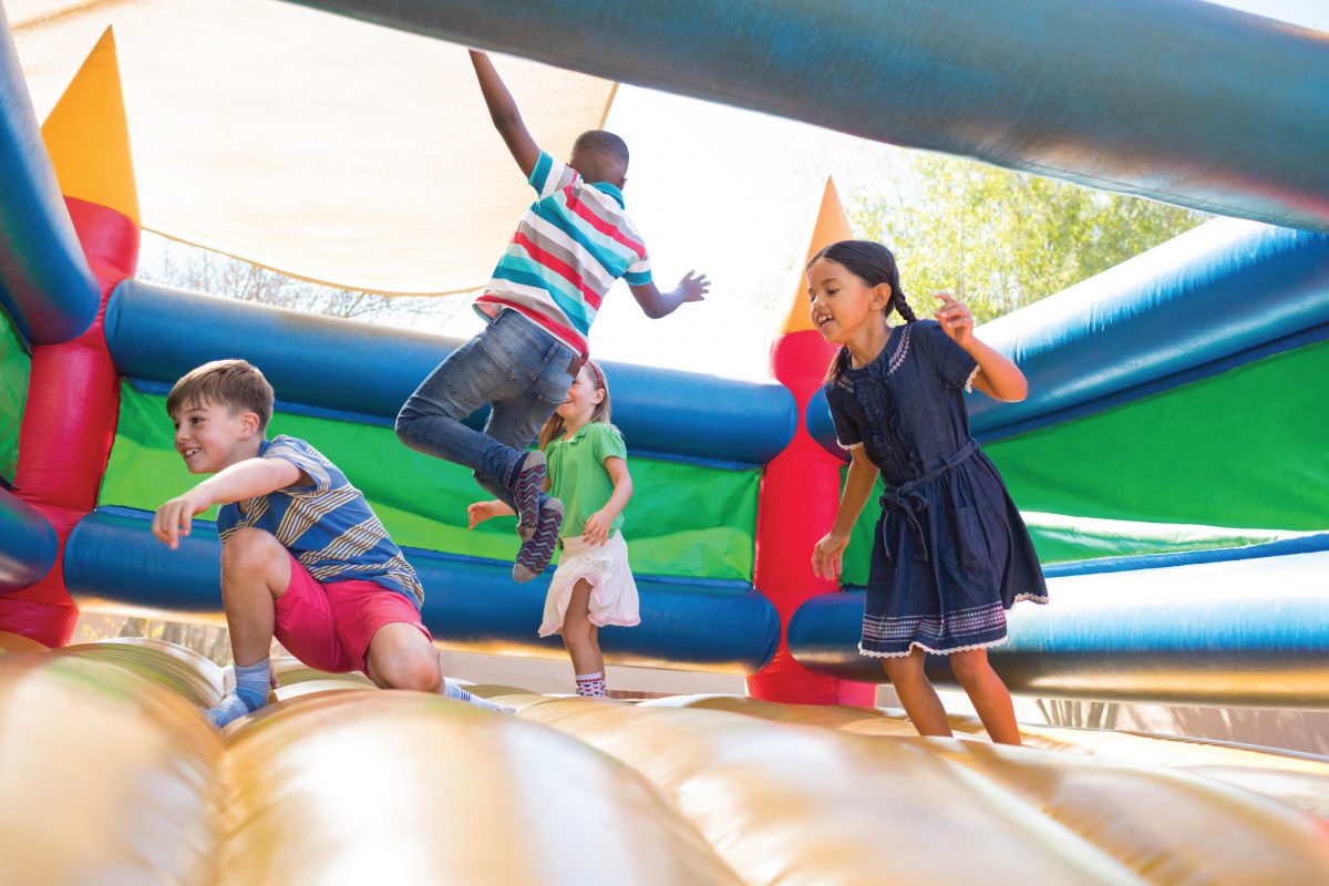 Kids on a bouncy castle having fun