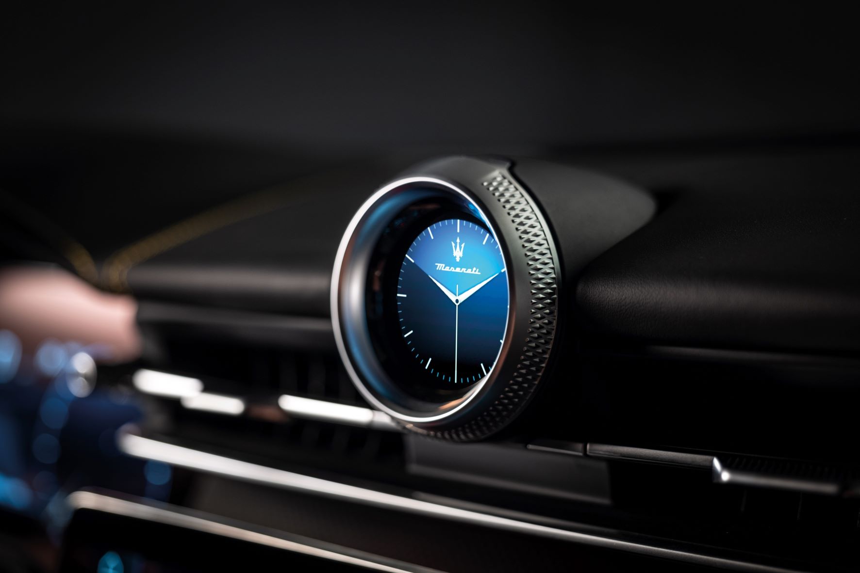 A Maserati analogue clock on the dashboard