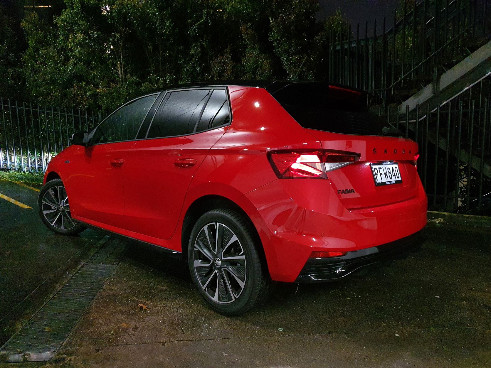 Rear three quarters view of a red Skoda Fabia Montecarlo at night