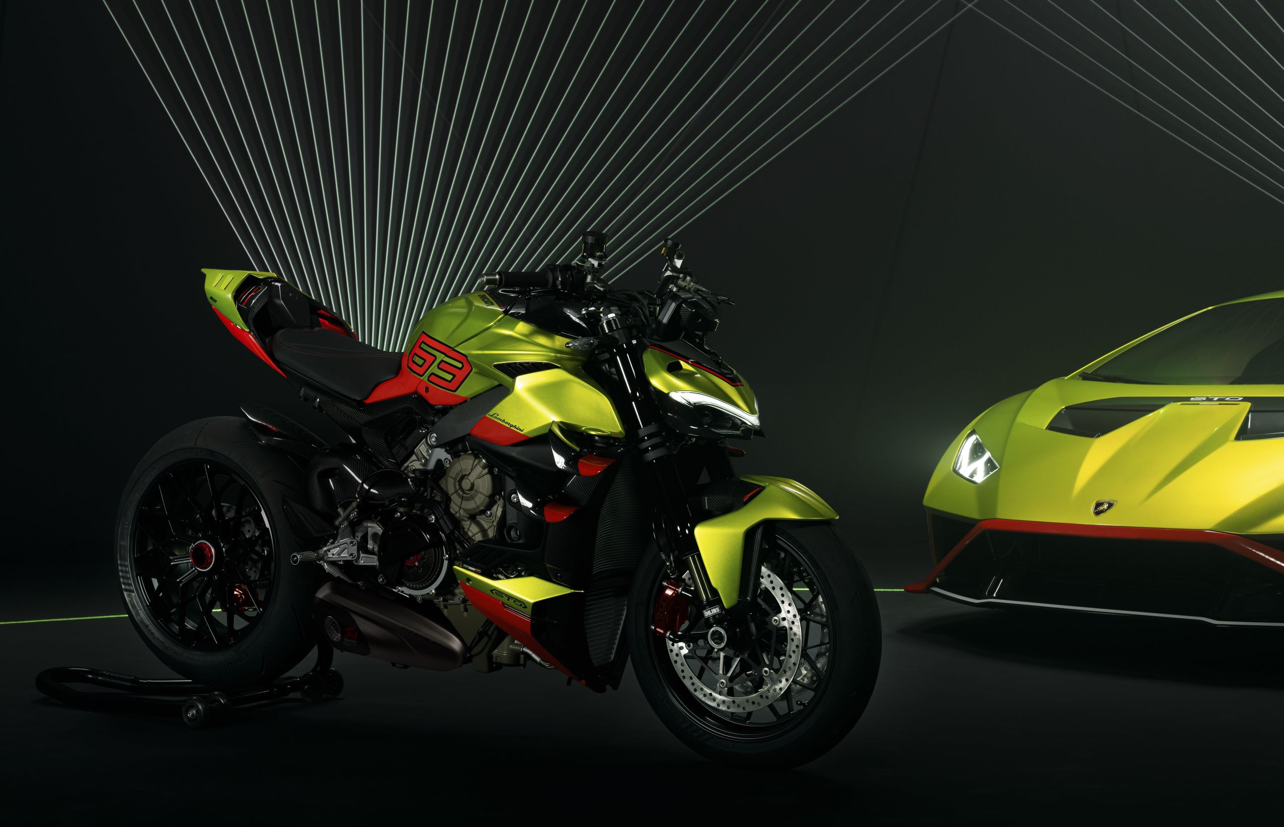 The Ducati Streetfighter V4 Lamborghini on the left and the Lamborghini Huracan STO on the right, both in green and orange livery