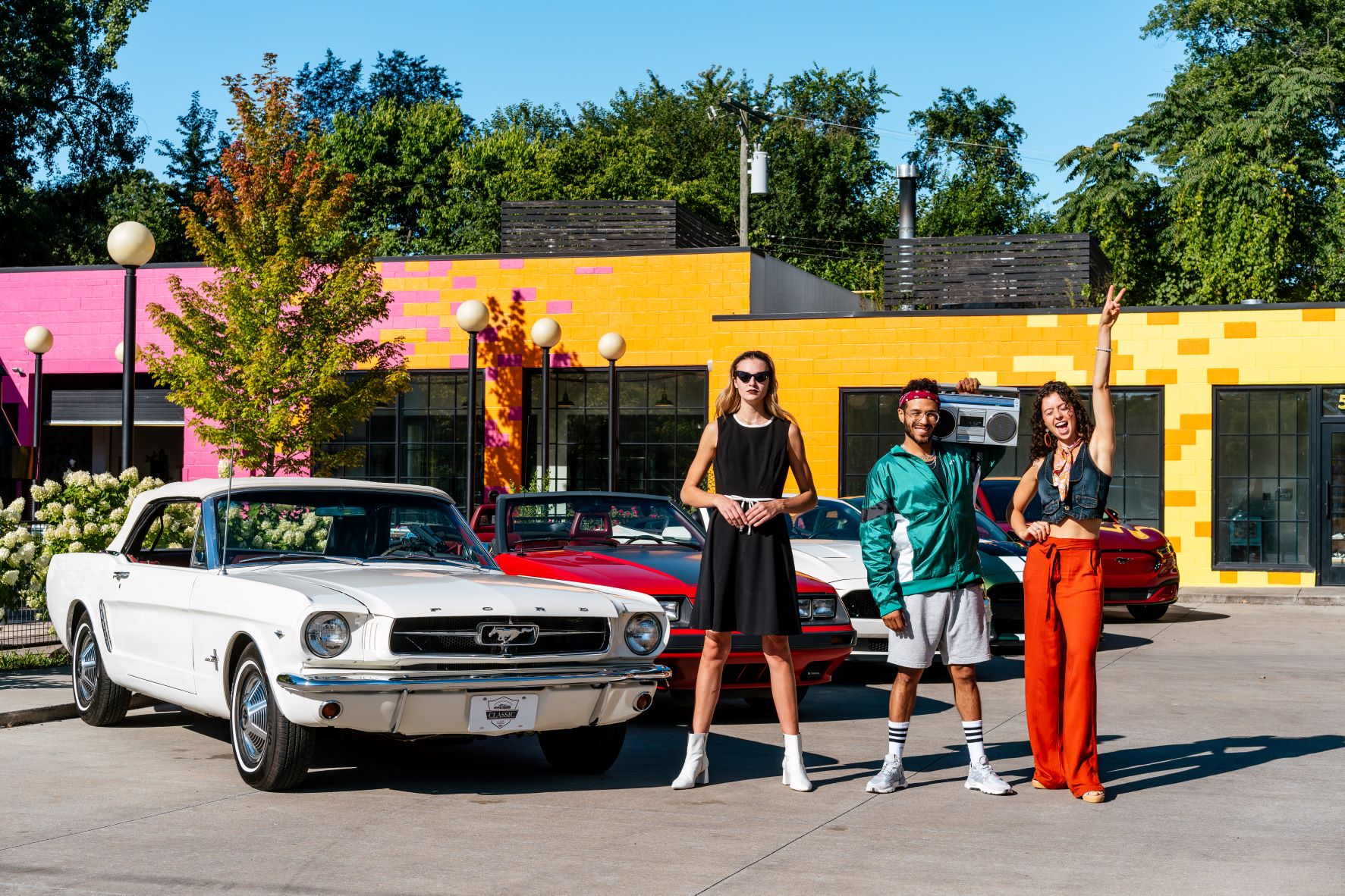 Ford Mustang fans pictured in attire to match the different decades of Ford Mustangs