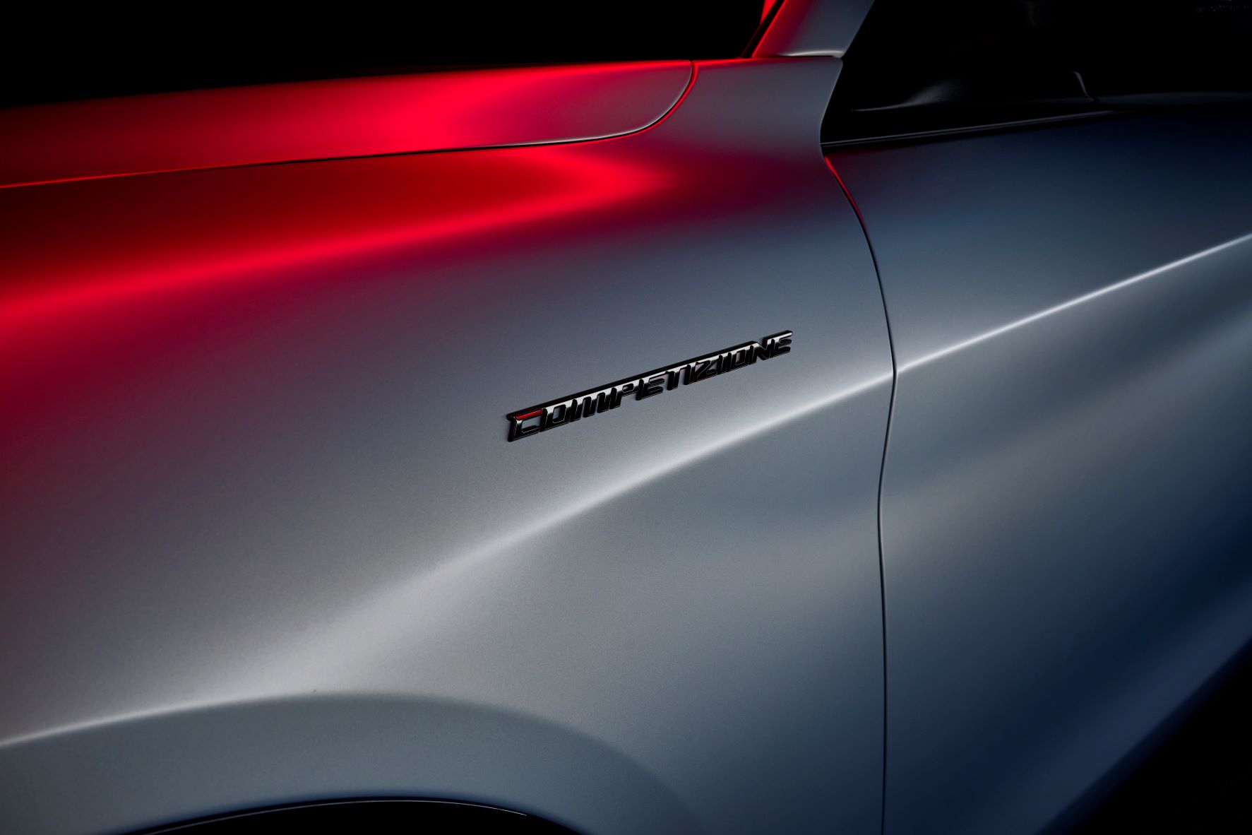 Competizione badging on the side of a 2023 Alfa Romeo Giulia sedan in Moonlight Gray