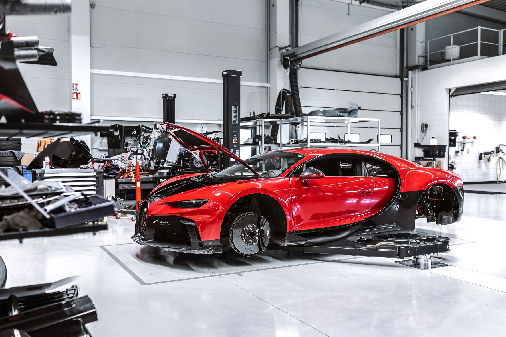 A Bugatti Chiron on a hoist at Bugatti