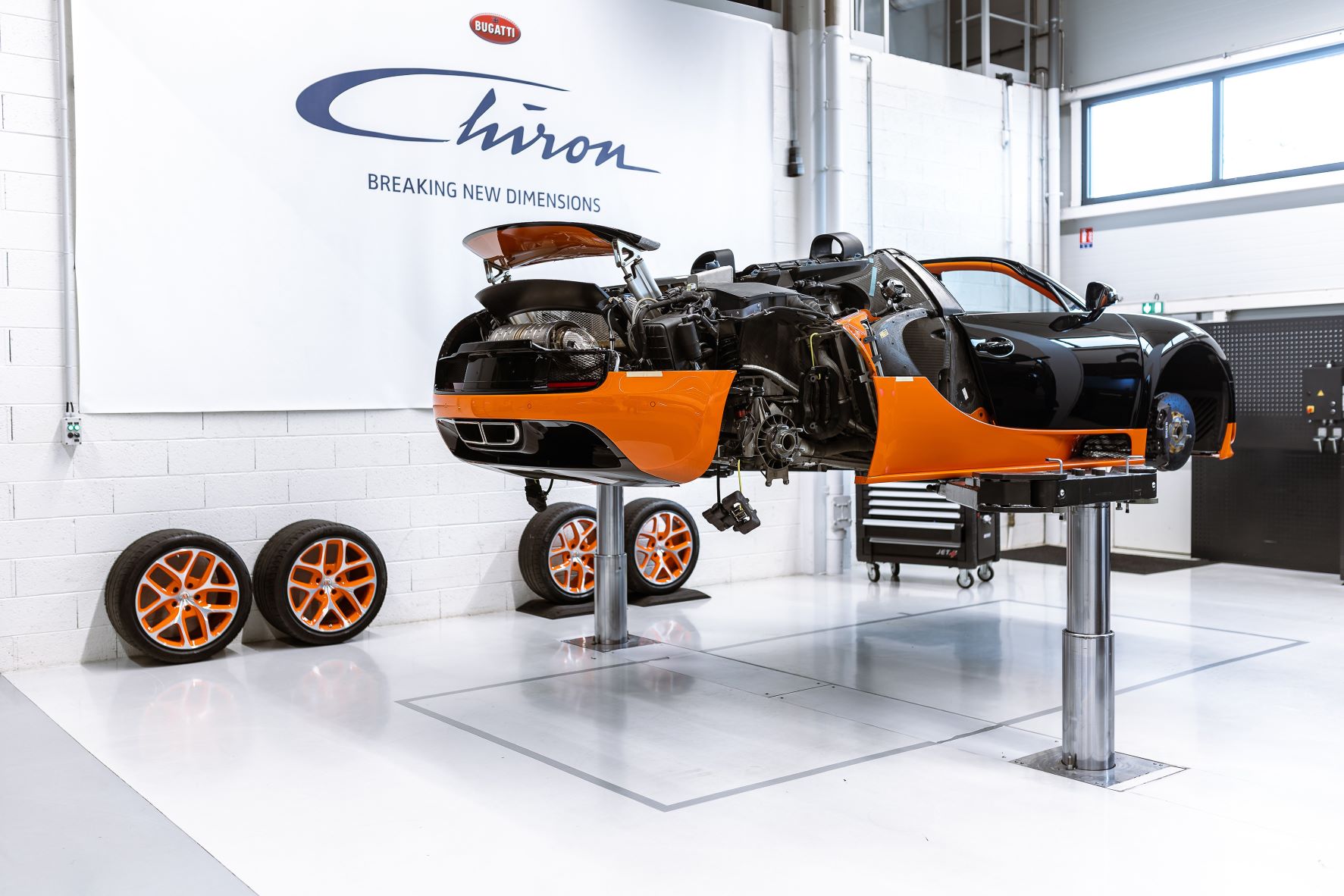 A Bugatti Veyron Grand Sport Vitesse on a hoist at Bugatti