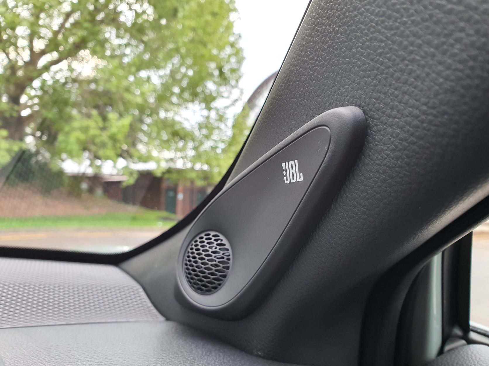 JBL audio system speakers on the interior of a 2022 Toyota Corolla Cross Limited Hybrid E-Four AWD in Safari Green