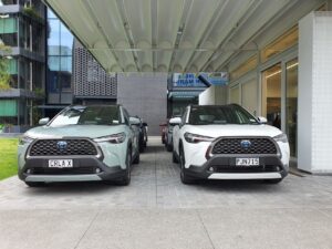 Front view of two new Toyota Corolla Crosses in white and green