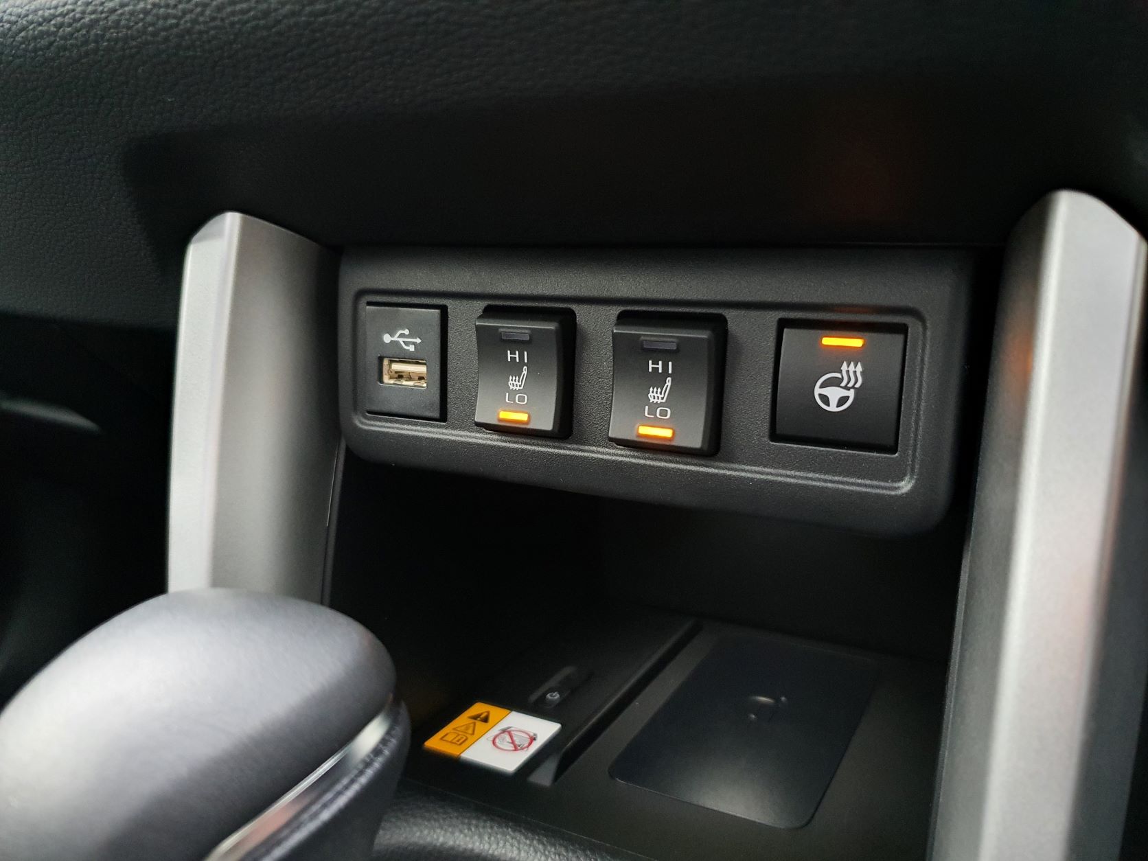 Seat & steering heating controls on a 2022 Toyota Corolla Cross Limited Hybrid E-Four AWD in Safari Green