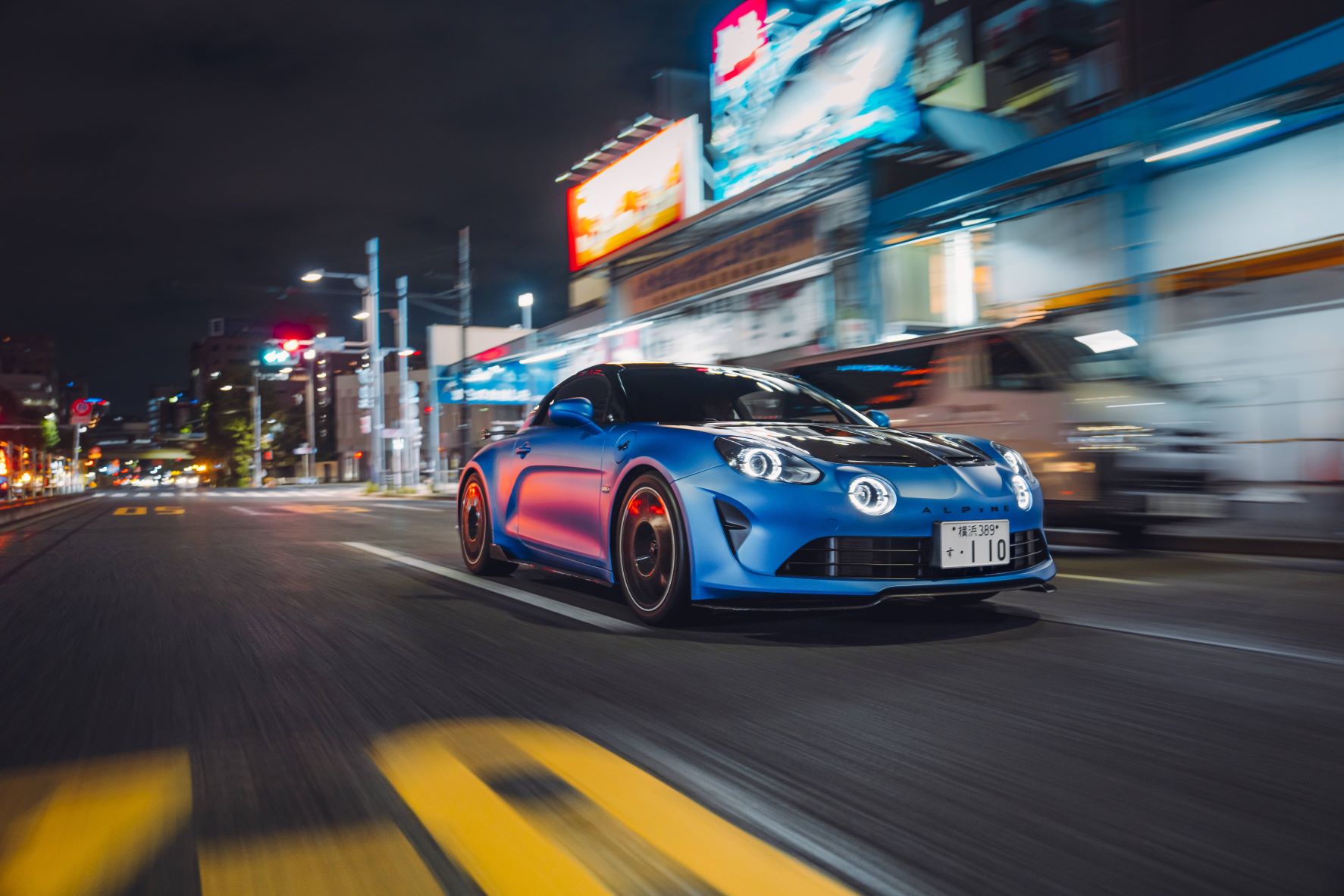 Rolling shot of the front three quarters of a new Alpine A110R in blue.