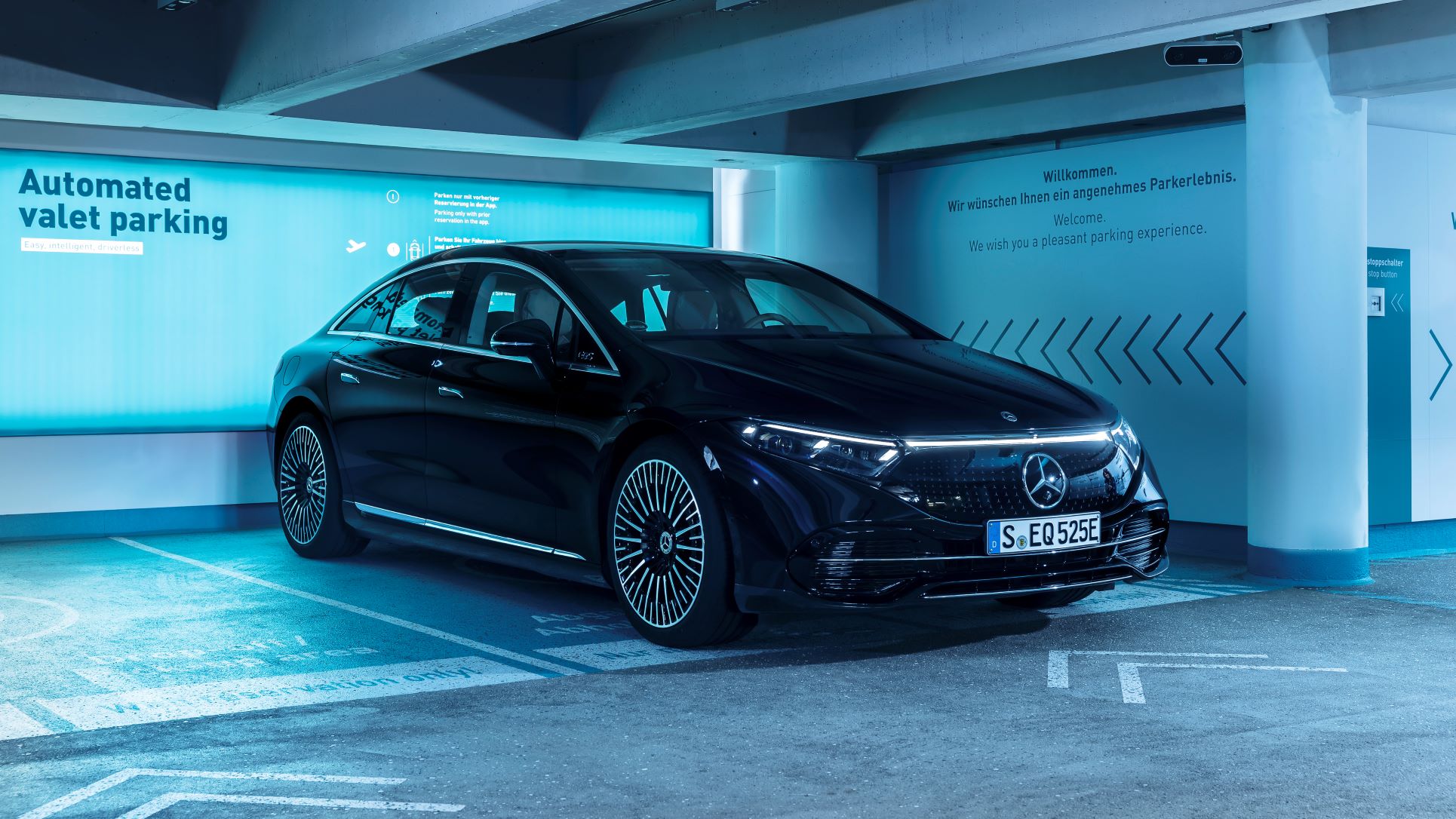 A black Mercedes-Benz EQS sedan parked in a Bosch Mercedes-Benz marked driverless parking bay.