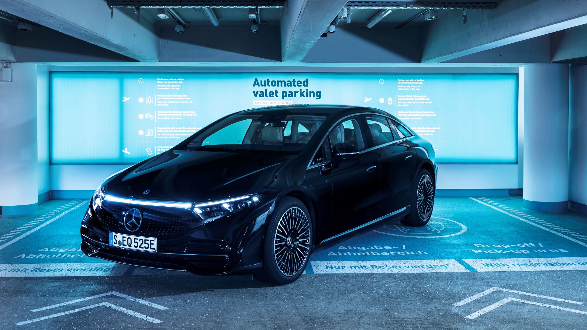 Front three quarters view of a black Mercedes-Benz EQS sedan at the dedicated Bosch Mercedes-Benz autonomous valet parking spots at Stuttgart Airport, Germany.