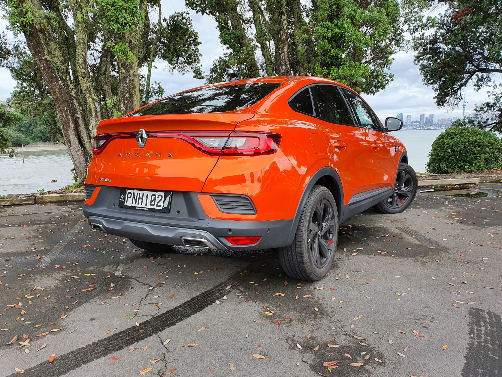 Rear three quarters view of a Valencia Orange Renault Arkana R.S Line