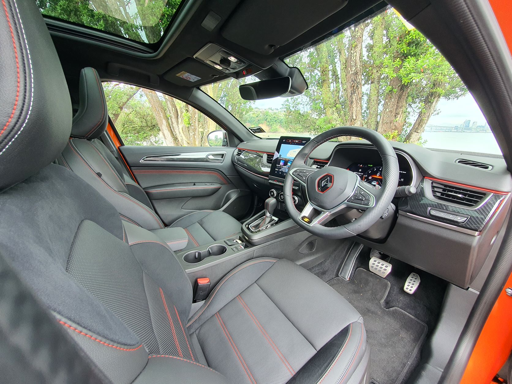 Interior view of a Valencia Orange Renault Arkana R.S Line