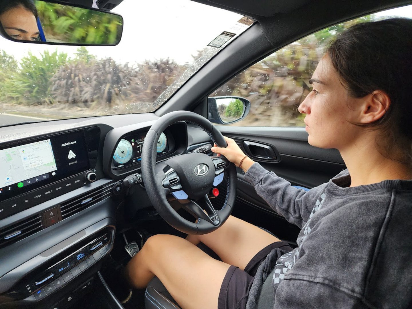 Woman driving a Hyundai i20 N in Hamilton, New Zealand