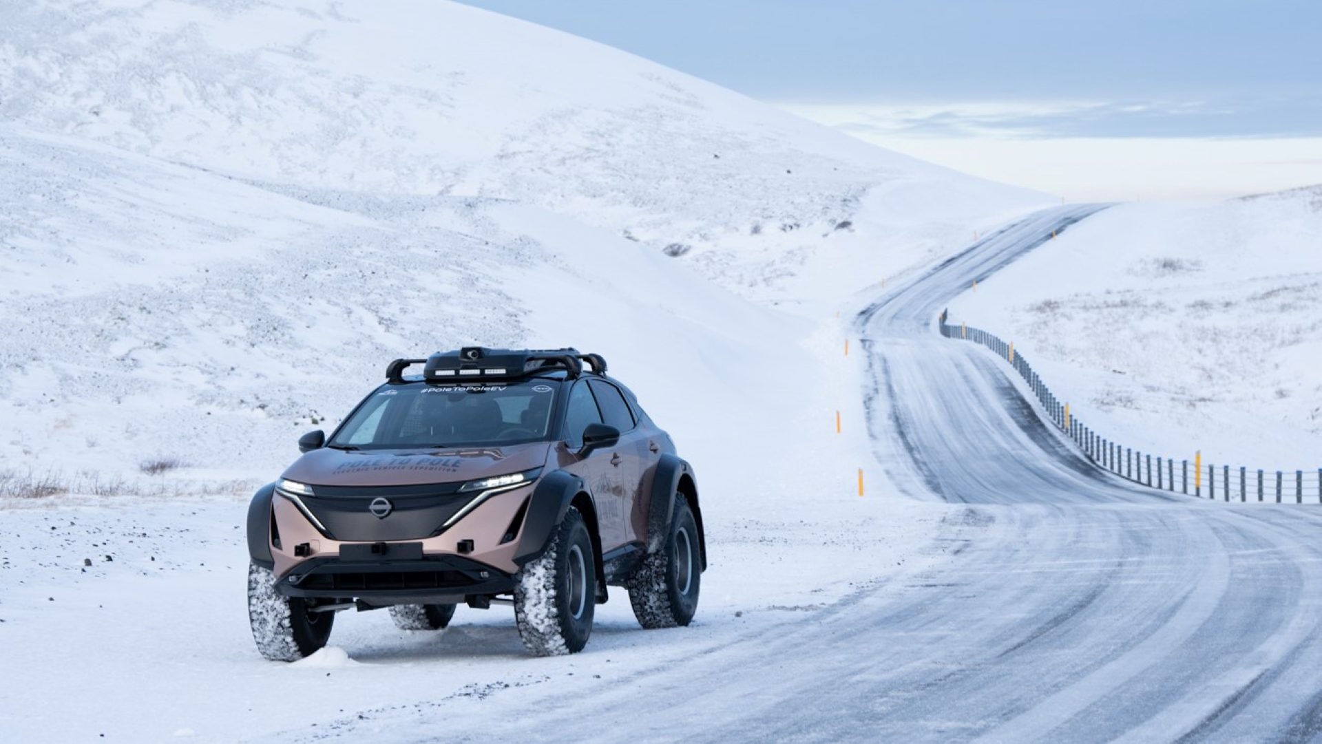 Zoomed out front three quarters view of the Pole to Pole Nissan Ariya EV with an icy backdrop of Iceland.