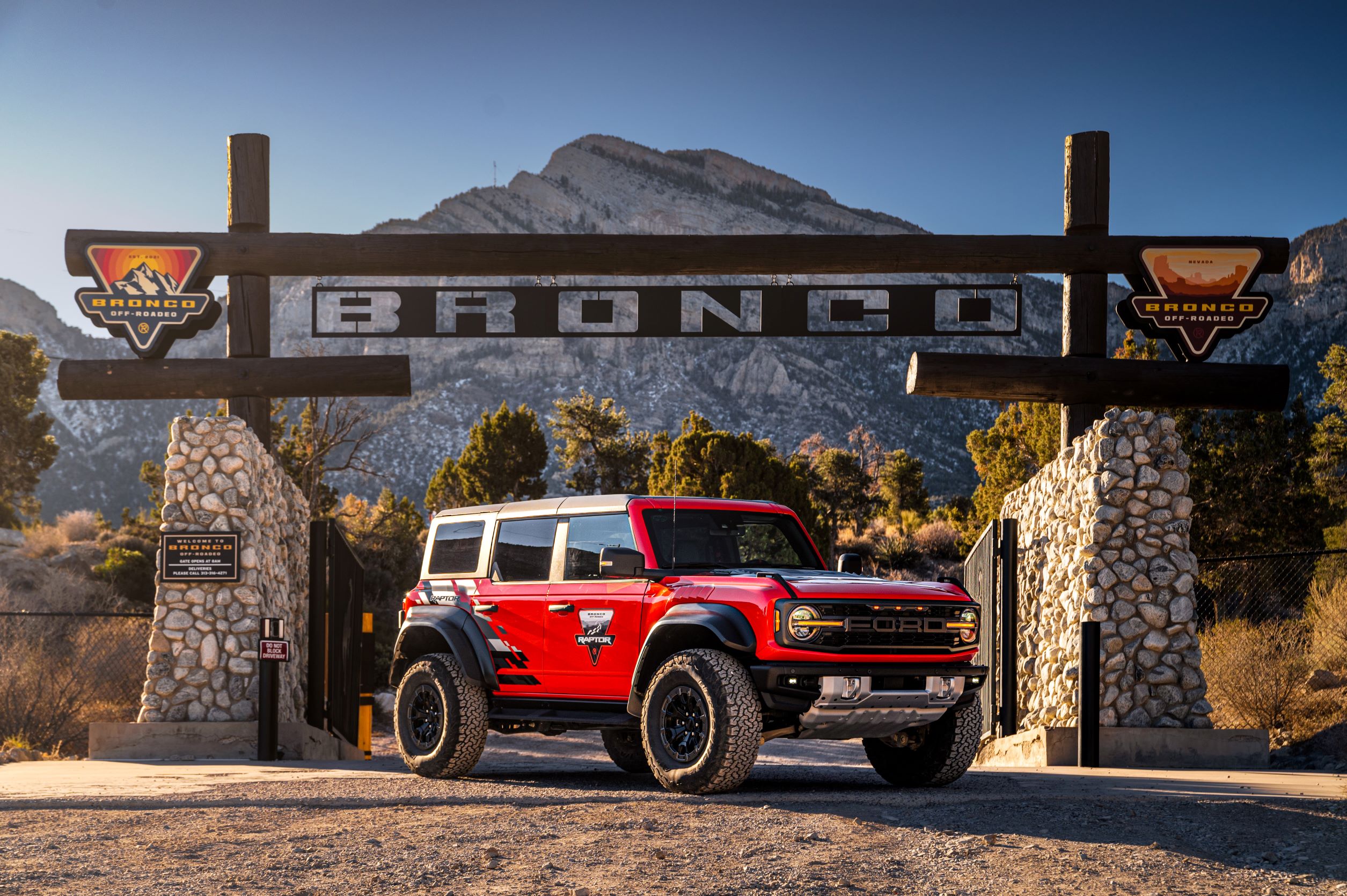 A red Ford Bronco Raptor pictured in front of the Ford Off-Roadeo School