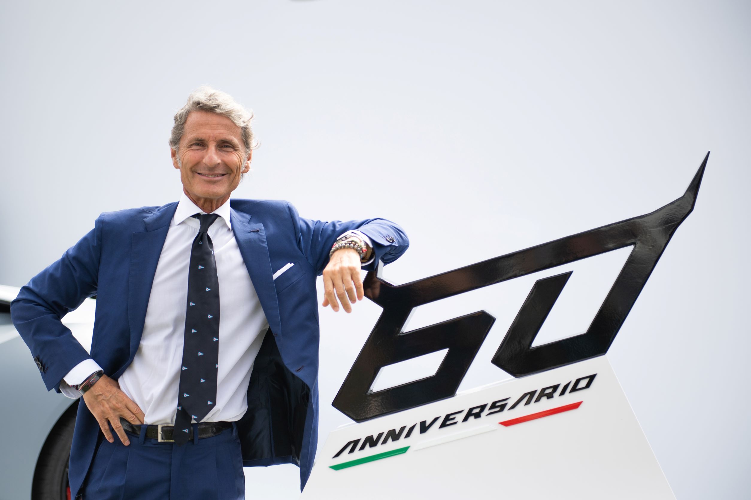 Stephen Winkelmann standing next to a Lamborghini 60th anniversary sign.