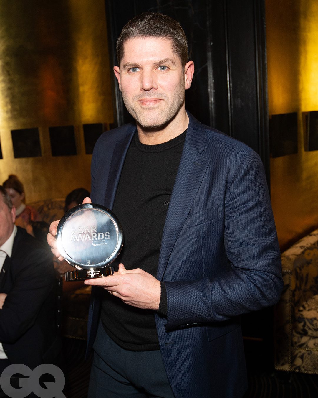 Matthew Hill, Head of Interior Design at Lotus collecting GQ's 'SUV of the Year' award for the Lotus Eletre