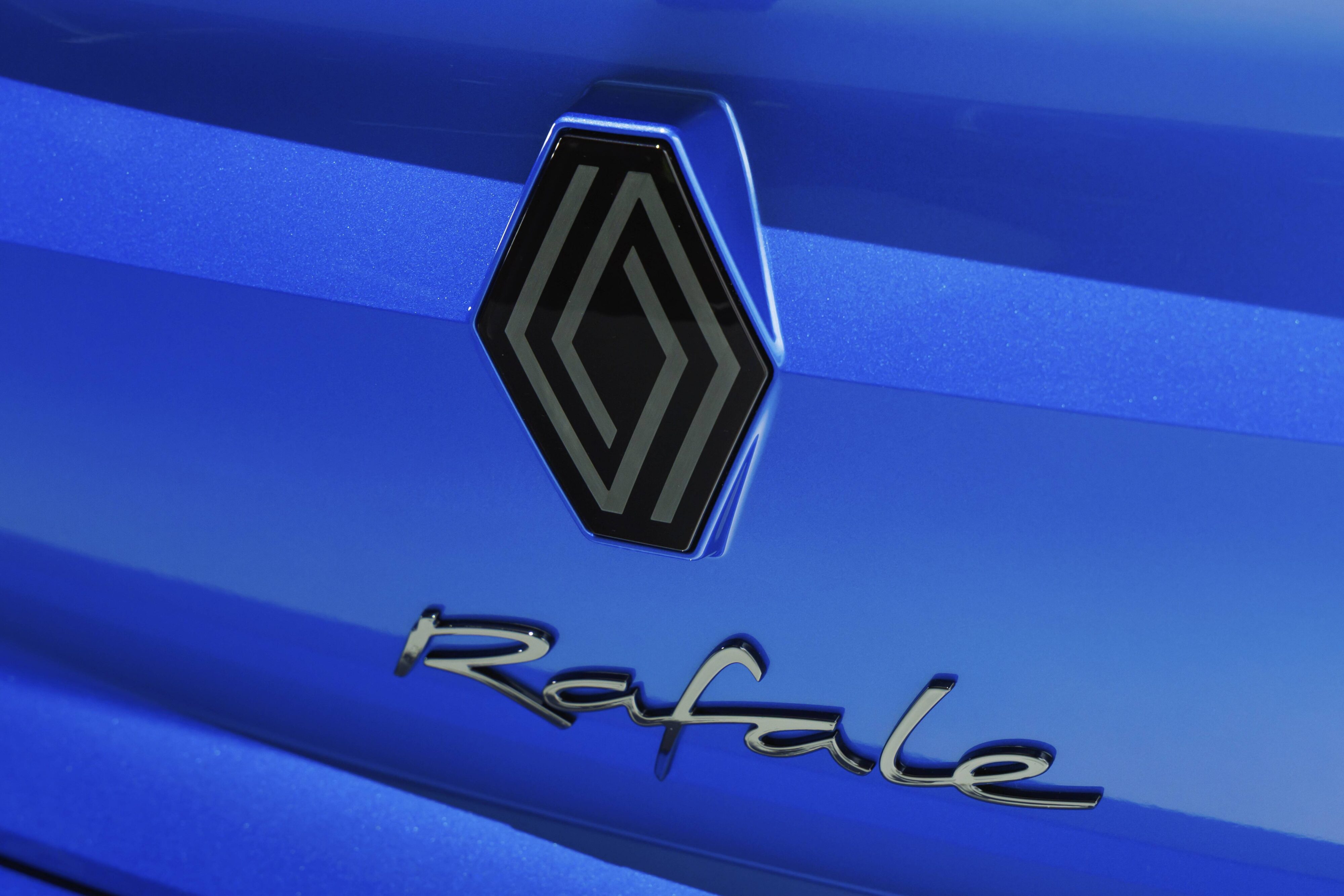 Focus on the Renault and Rafale badge on the rear of the Renault Rafale SUV in Alpine Blue