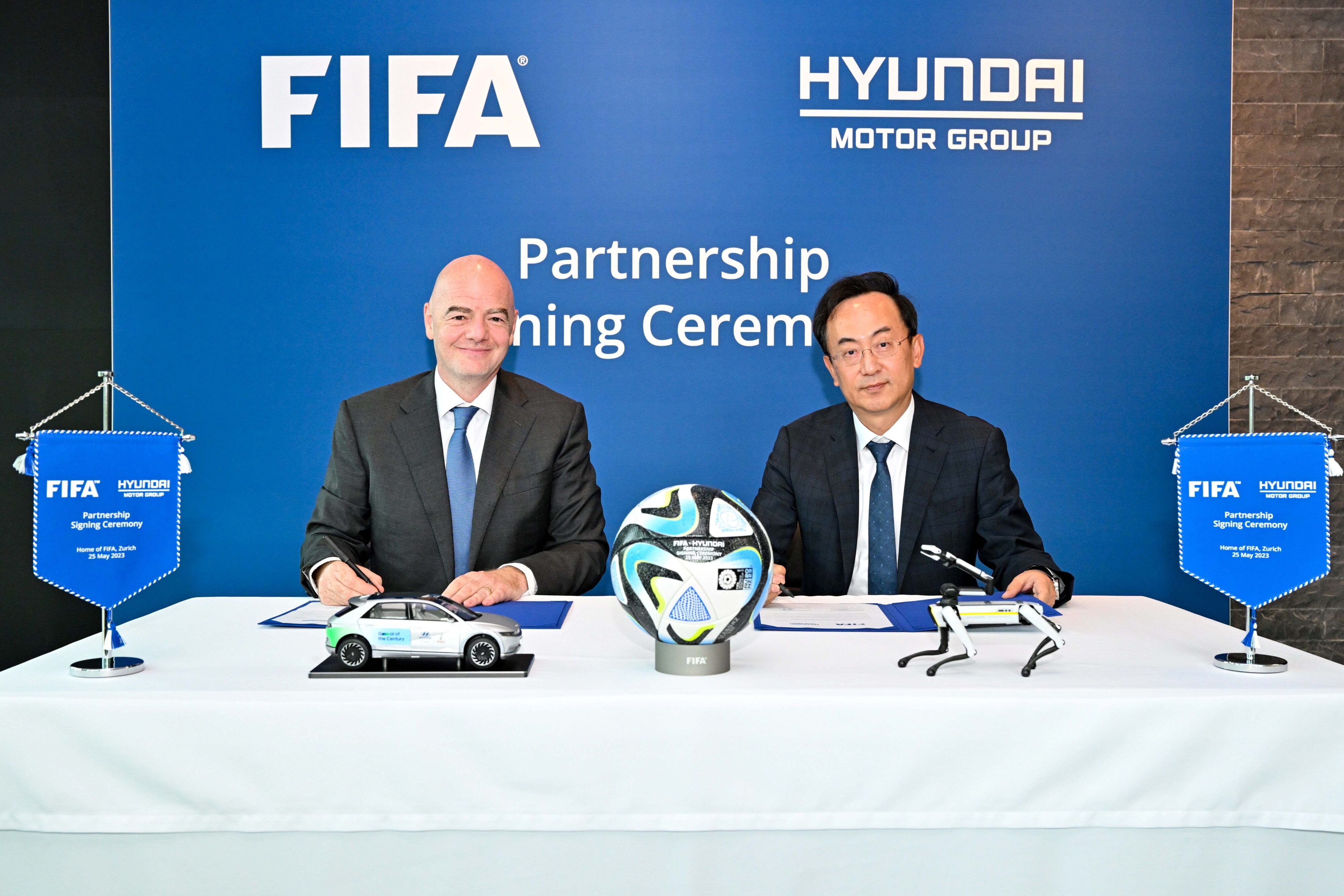 Representatives from Hyundai Motor Group and FIFA signing an agreement to extend the partnerships of the two brands.