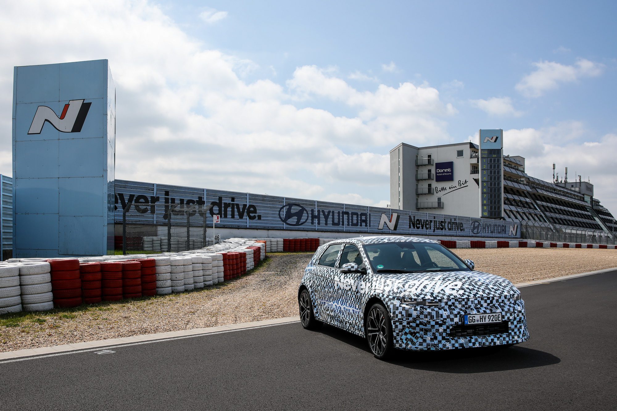 Promo shot of a camouflaged Hyundai IONIQ 5 N at Hyundai's N performance facility at the Nurburgring in Germany.