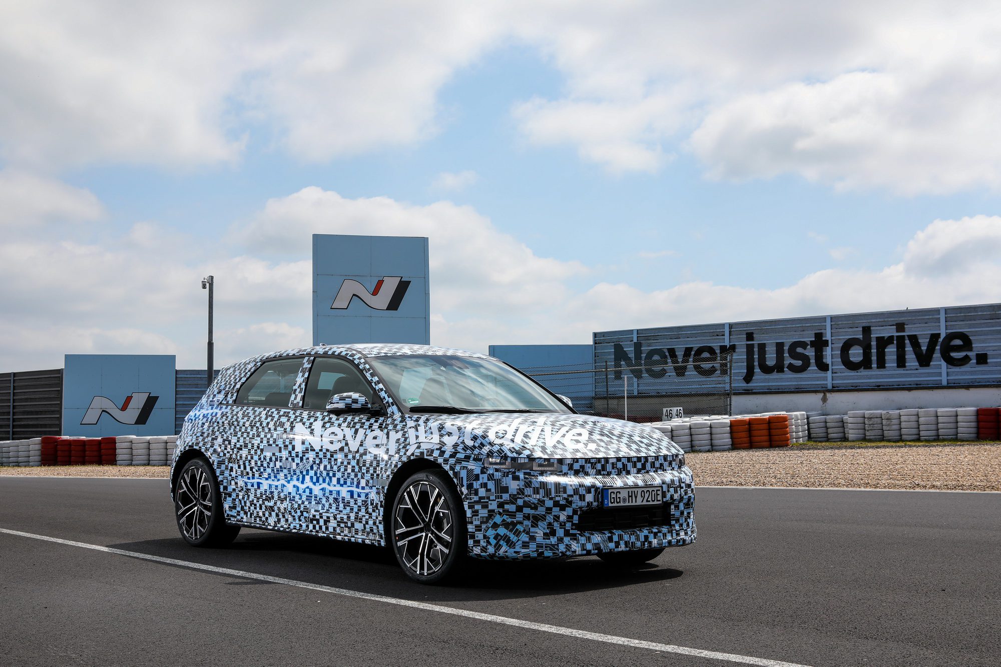 Promo shot of a Hyundai IONIQ 5 N under camouflage at the Hyundai N test facilities at the Nurburgring in Germany.