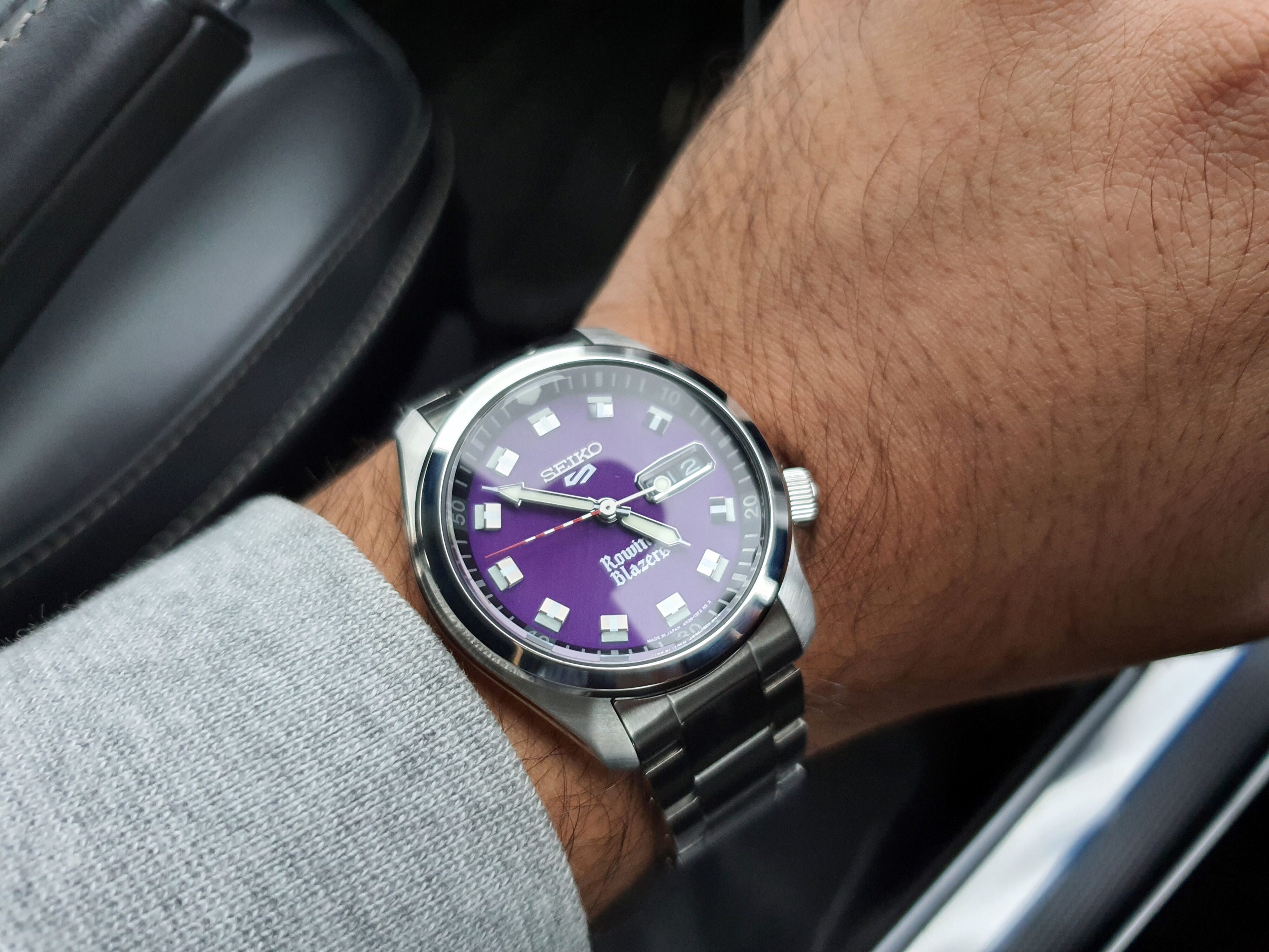 A shot of the Seiko 5 x Rowing Blazers collaboration purple dial wristwatch on the wrist of Matthew D'Souza