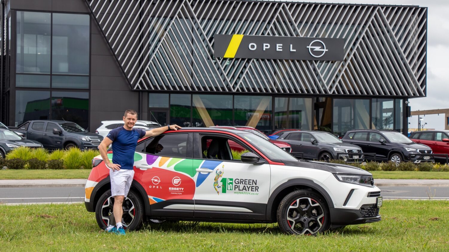 Wojtek Czyz, Paralympian, with his Ebbett sponsored Opel Mokka-e EV.