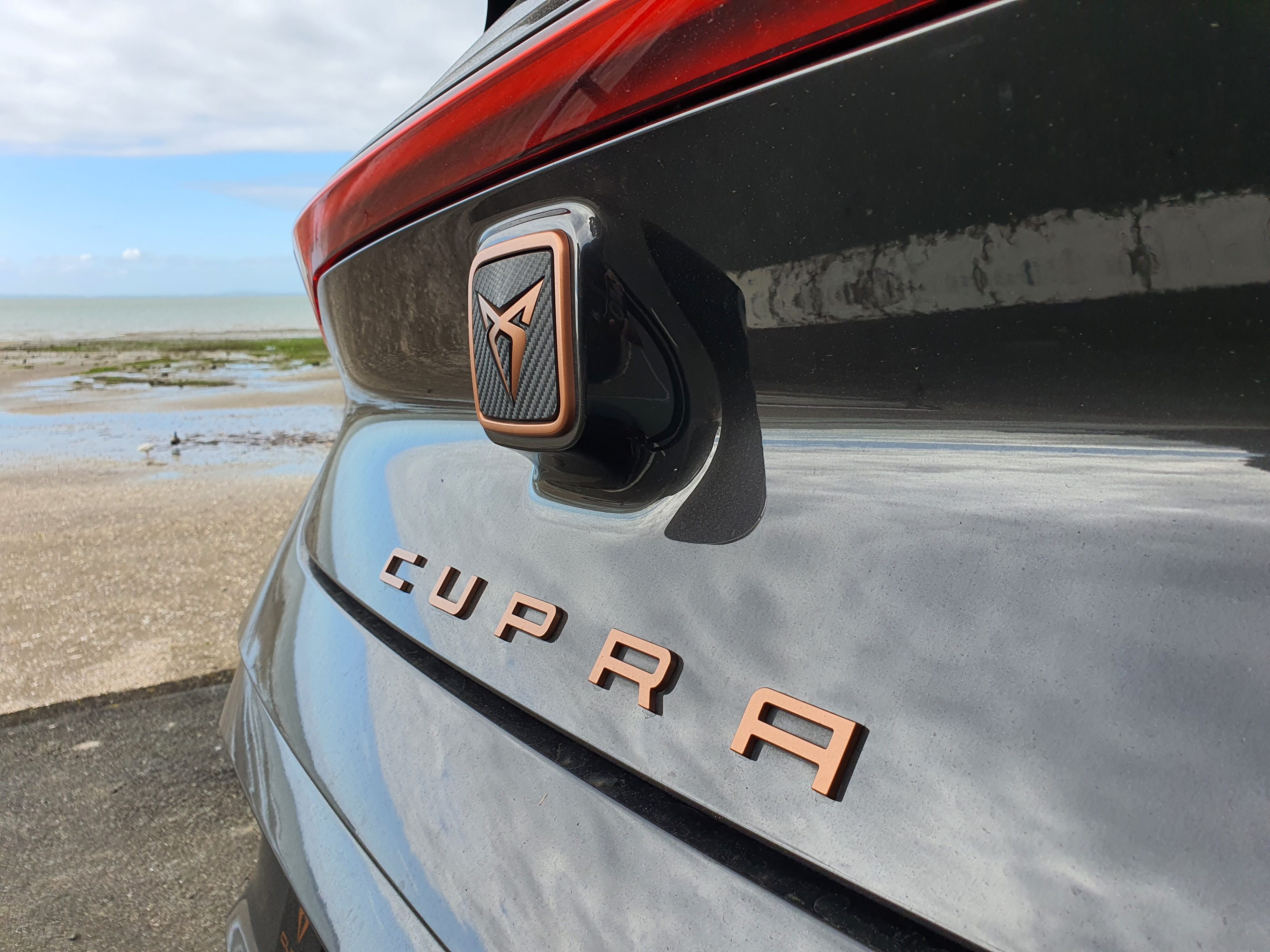 Photo focusing on the rear Cupra badge on a 2023 Cupra Born V+ in Quasar Grey.