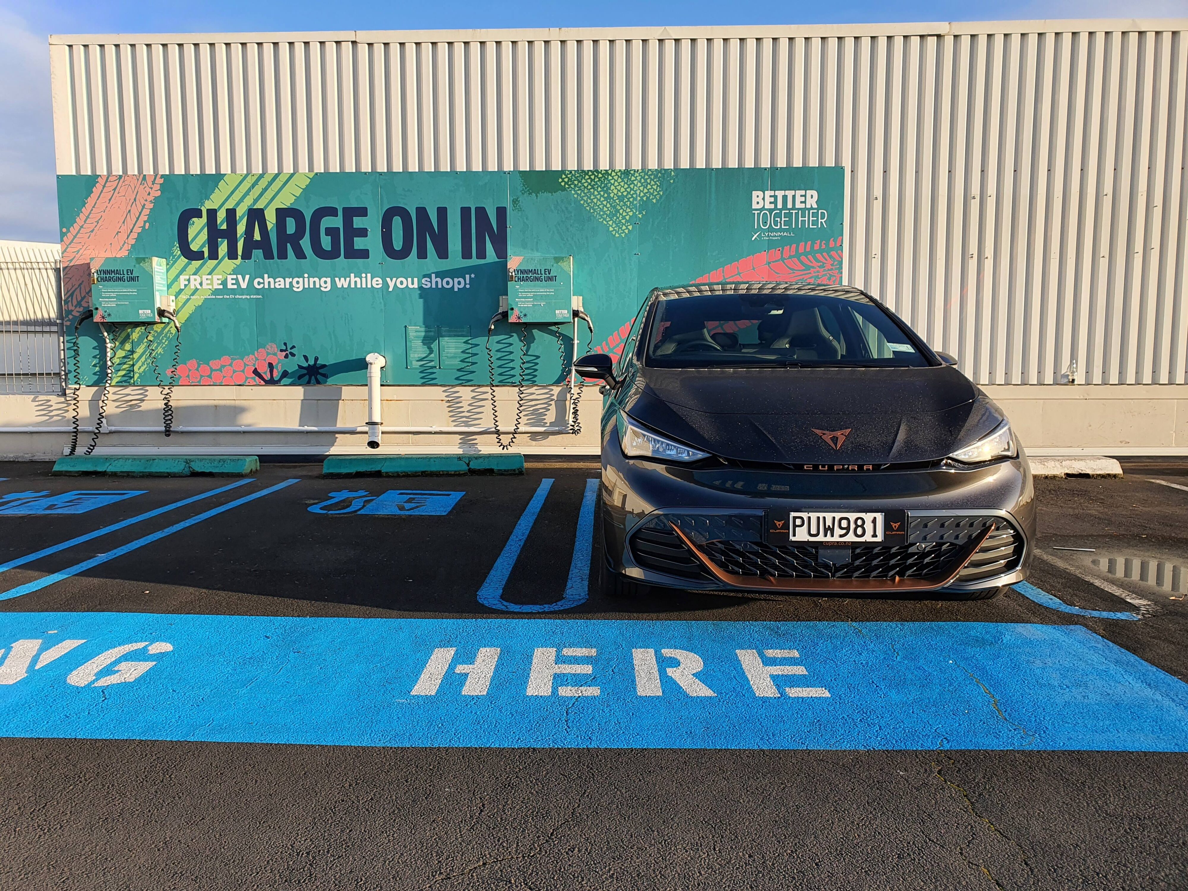 Photo of a 2023 Cupra Born V+ in Quasar Grey parked at a charging station at Lynnmall.