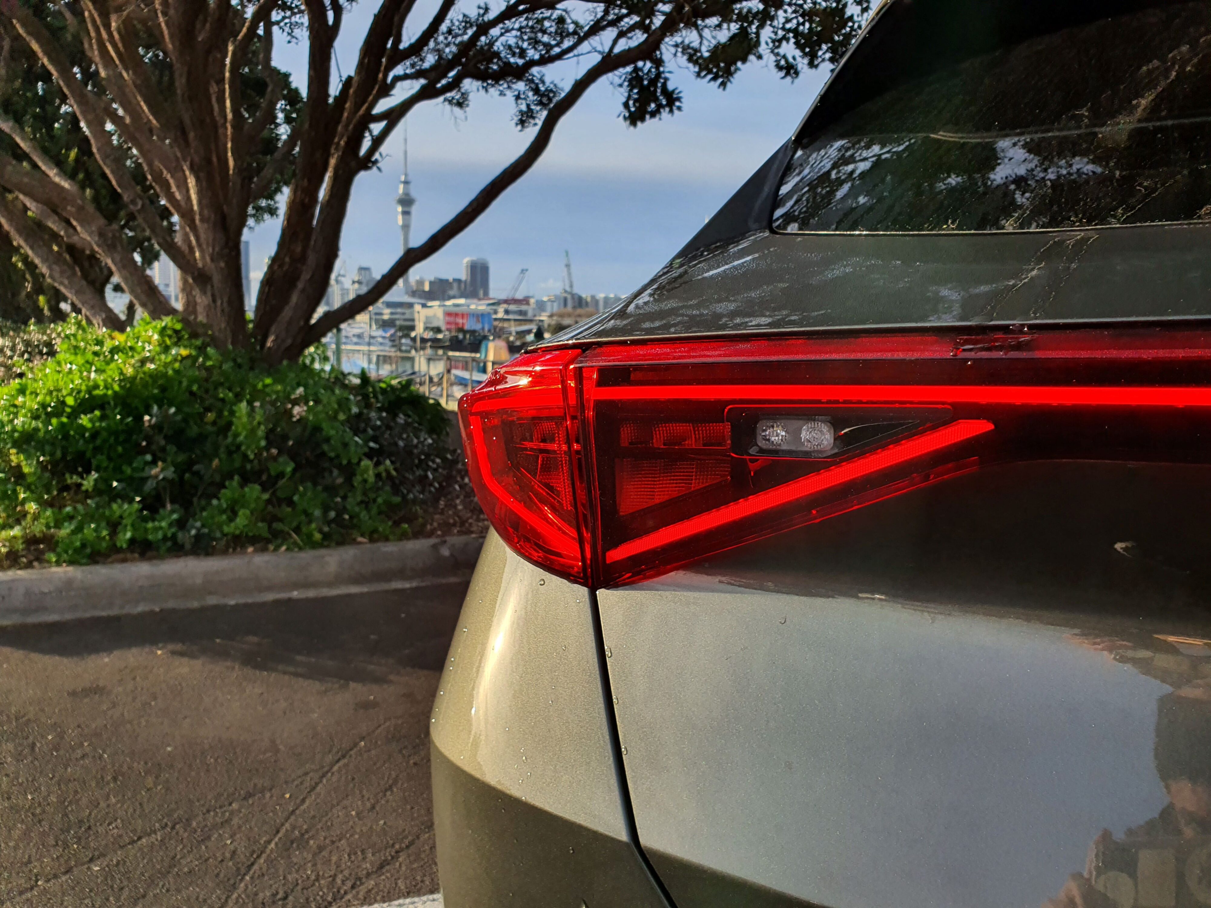 Close-up of the light bar on a 2023 Cupra Formentor VZ Tribe Edition with Auckland City in the background.