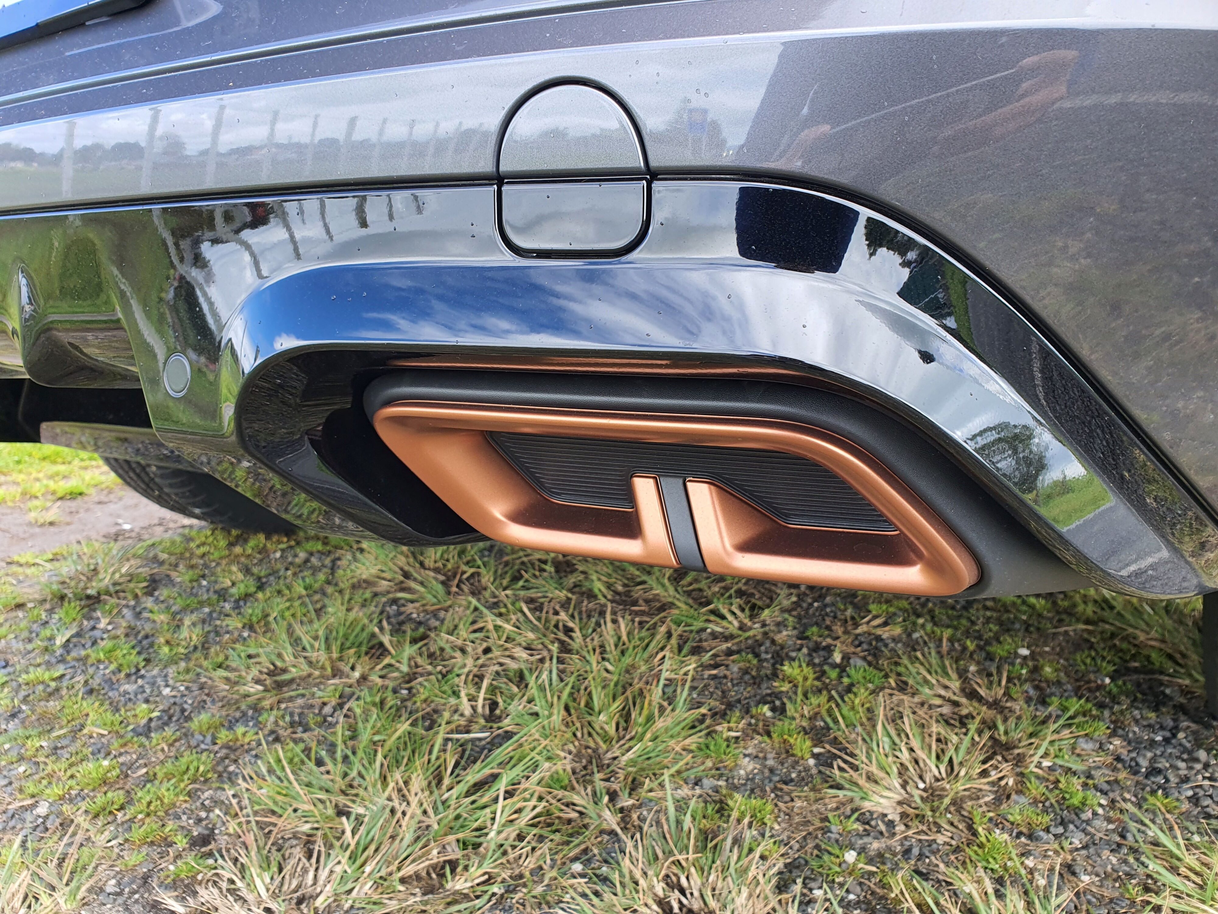 A close-up on the Copper simulated exhaust tips on a 2023 Cupra Formentor V e-Hybrid.