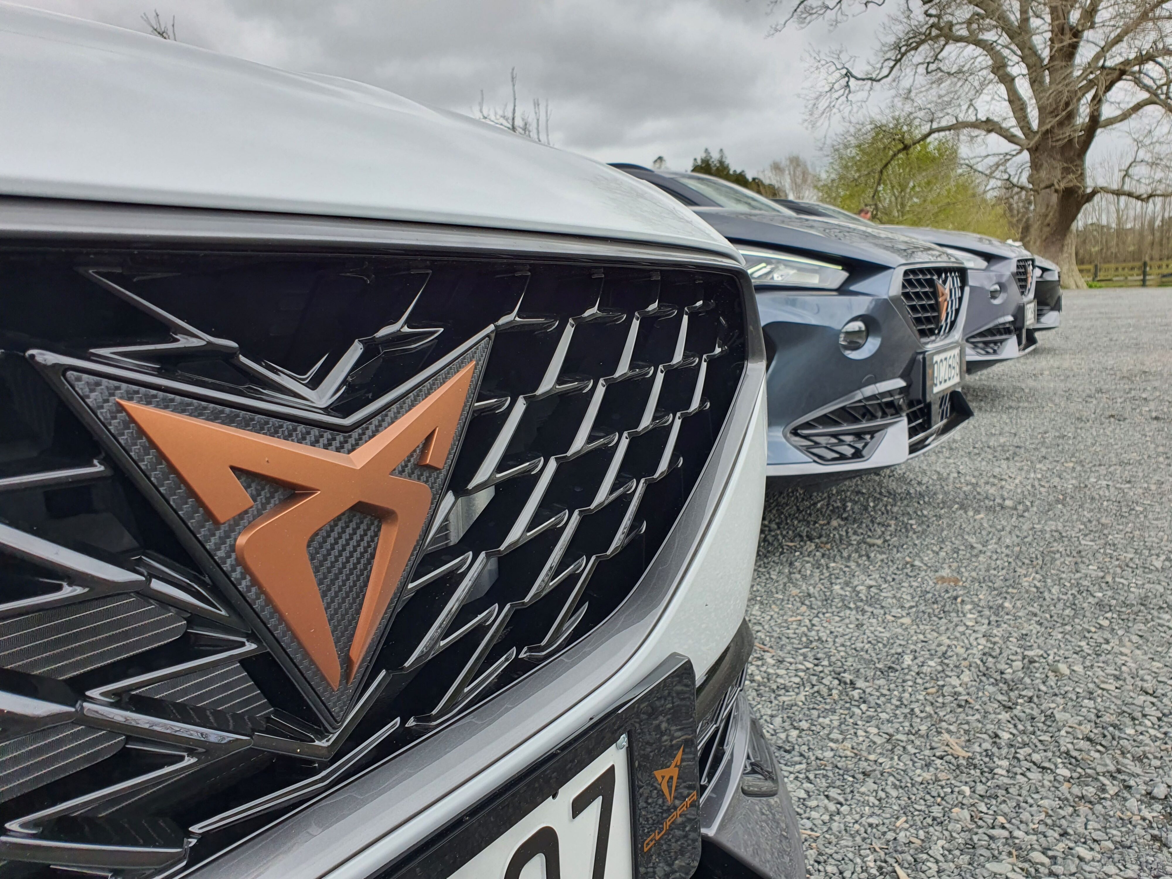 Close-up photo of the Cupra logo on the front of a 2023 Cupra Formentor V e-Hybrid.