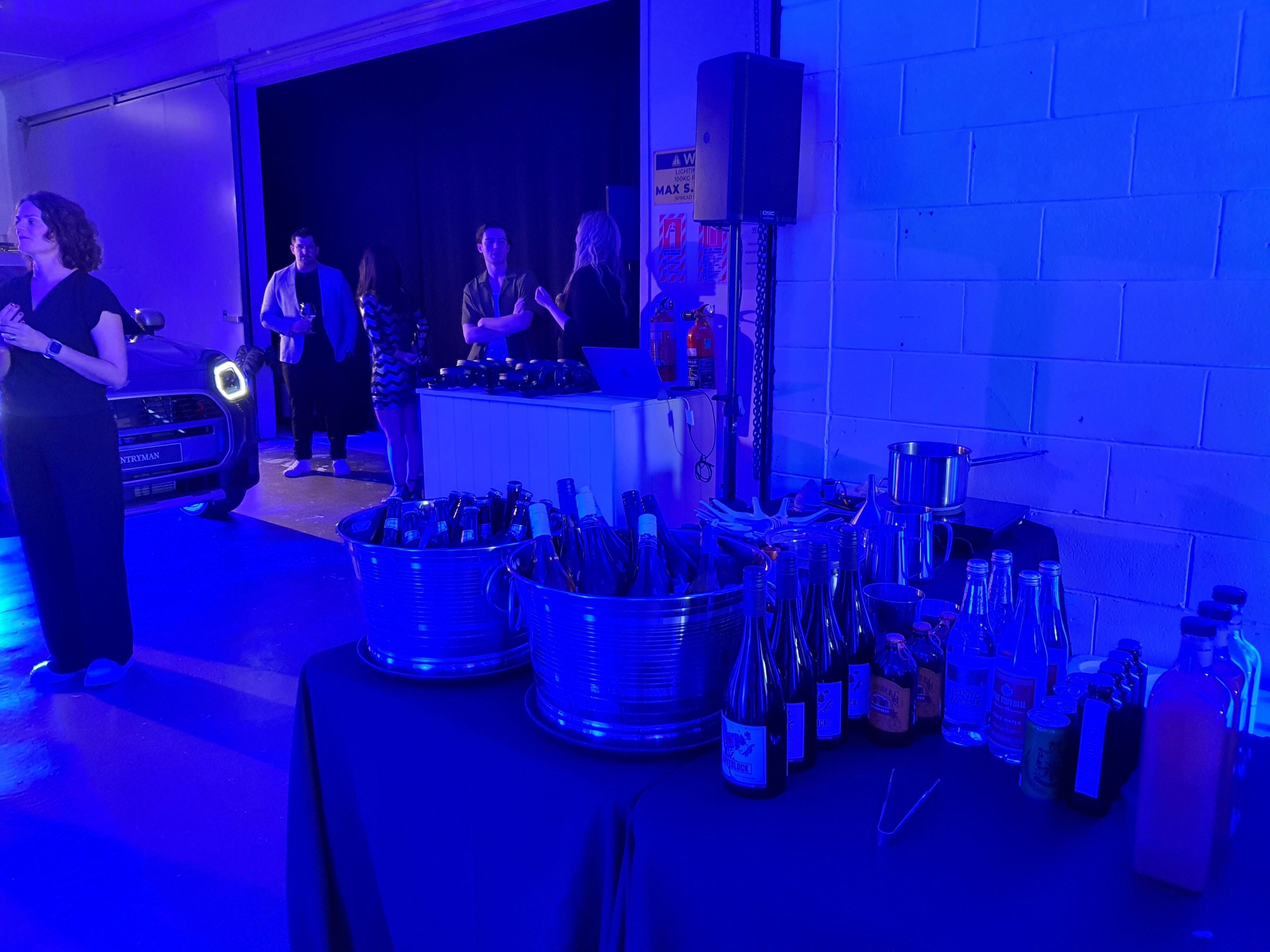 A photo of the inside of Studio 230, Ponsoby with a bar full of drinks, prepared for the unveiling of Mini's new design language.