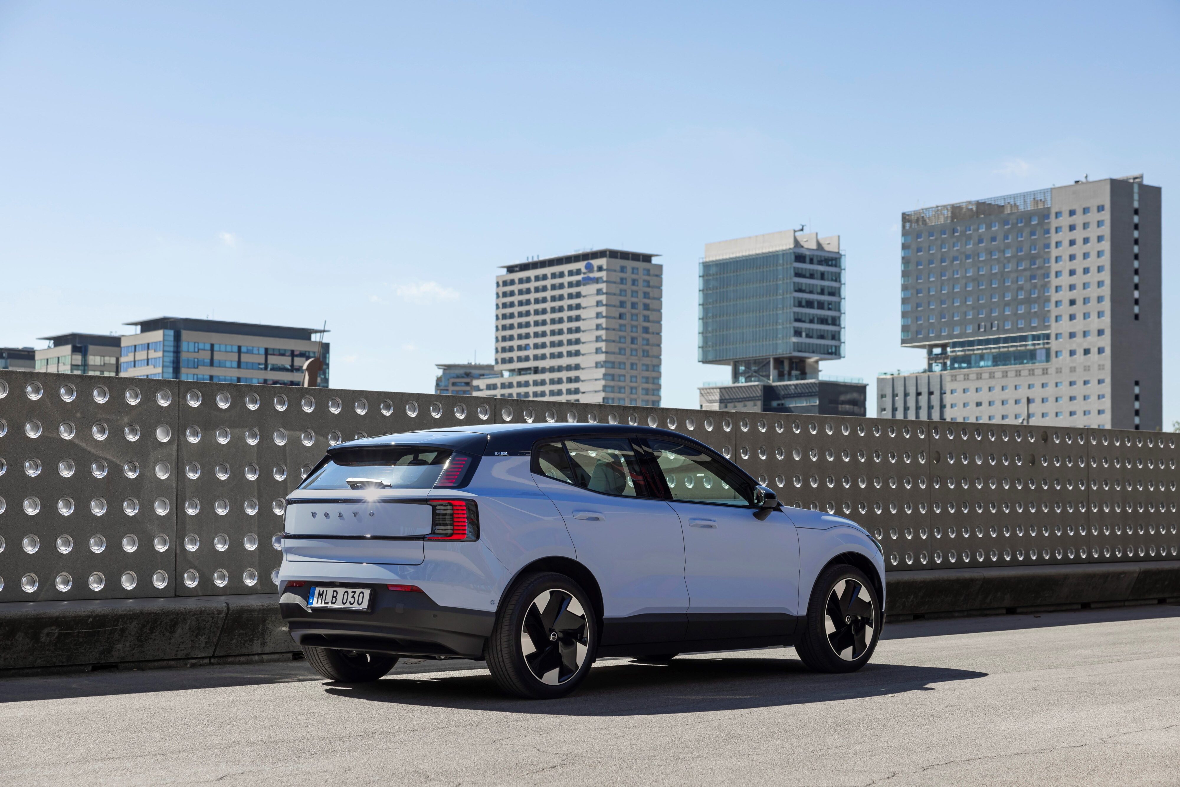 Rear three quarters view of a 2023 Volvo EX30 in Cloud BLue.