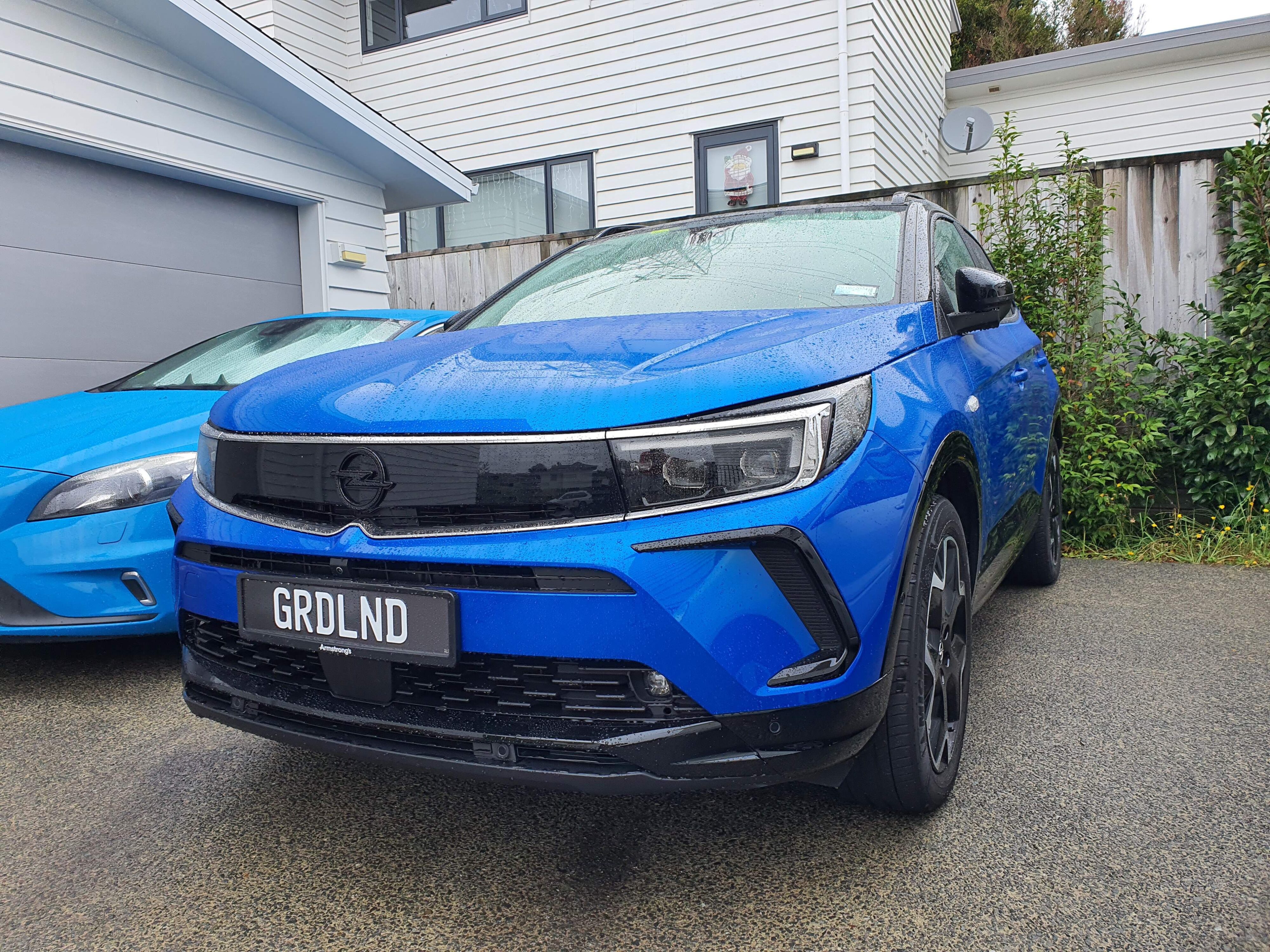 Photo of a Cobalt Blue Opel Grandland SRi on a driveway.