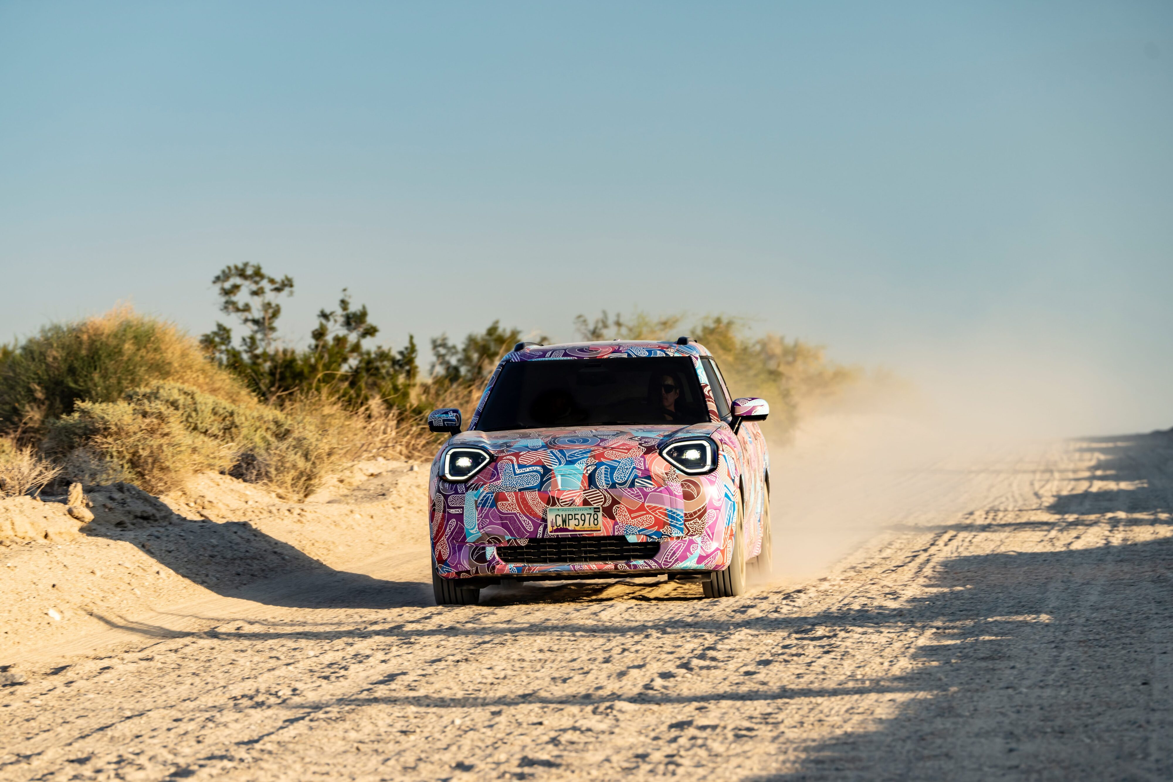 Promotional photo of a Mini Aceman in camouflage undergoing desert testing.