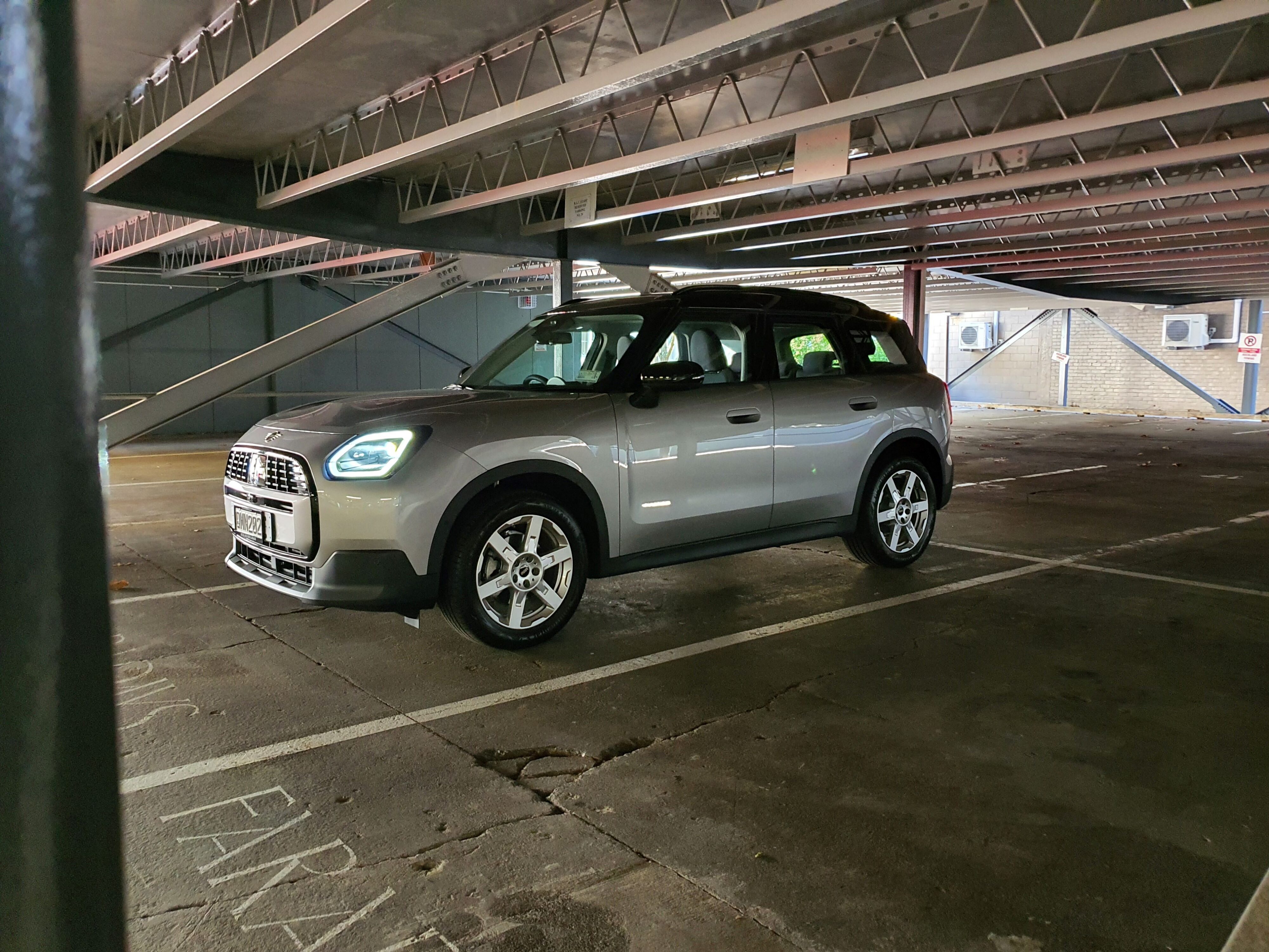 Front three quarters view of a 2024 Mini Countryman C Classic in Silver in an underground carpark.